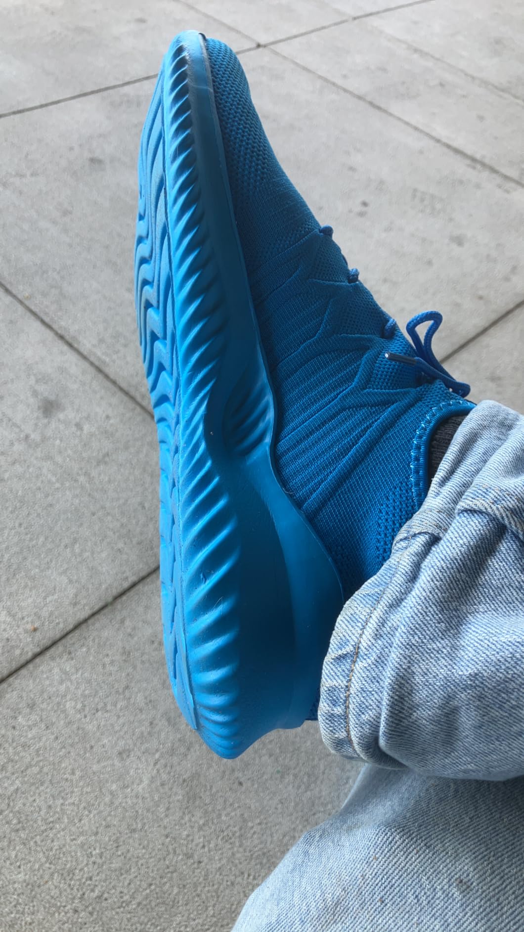 Mens slip on running shoes light blue colorway showing mesh upper and flexible sole design
