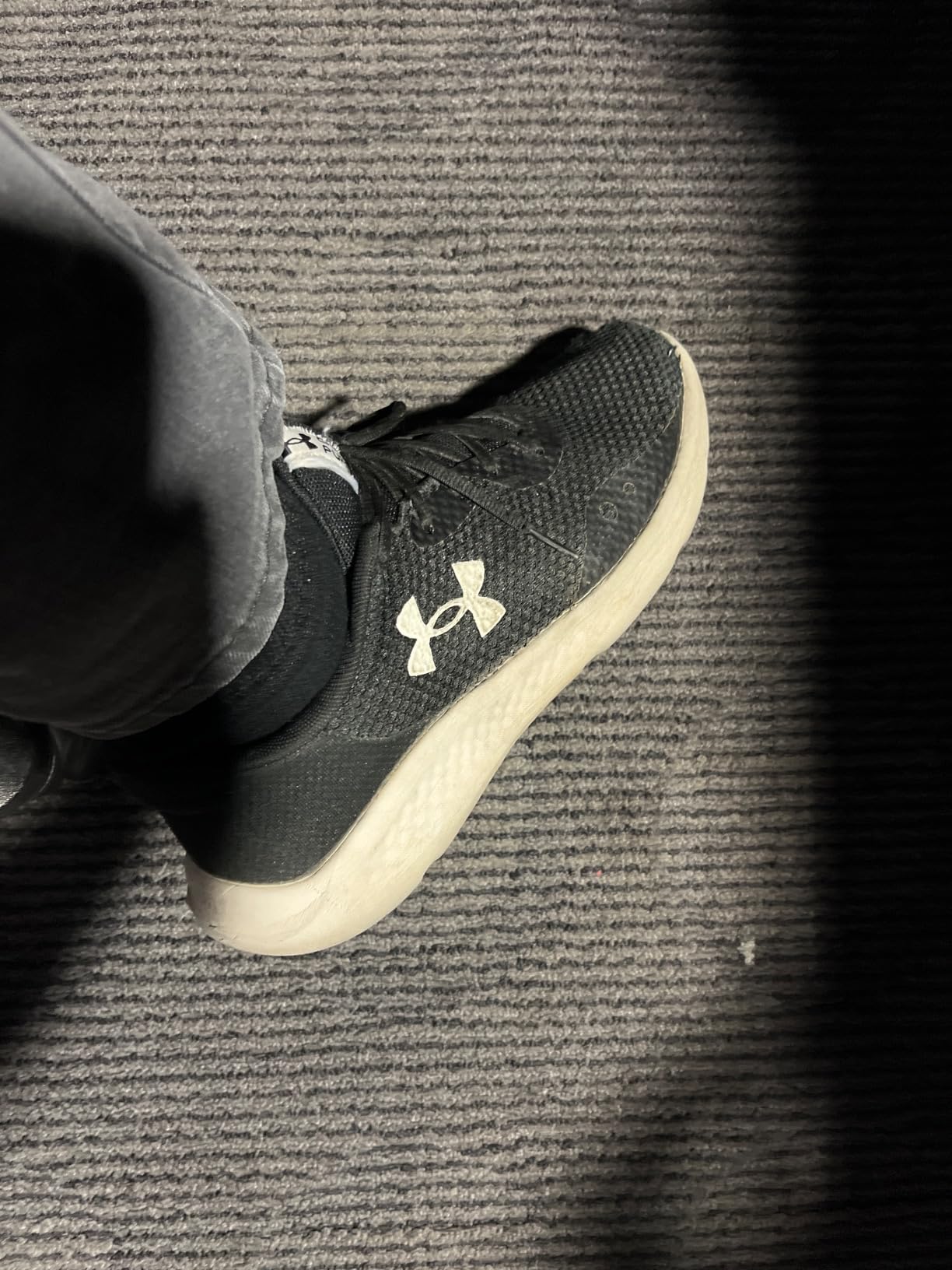 Under Armour Charged Pursuit 3 running shoes showing mesh upper design and charging cushioning technology