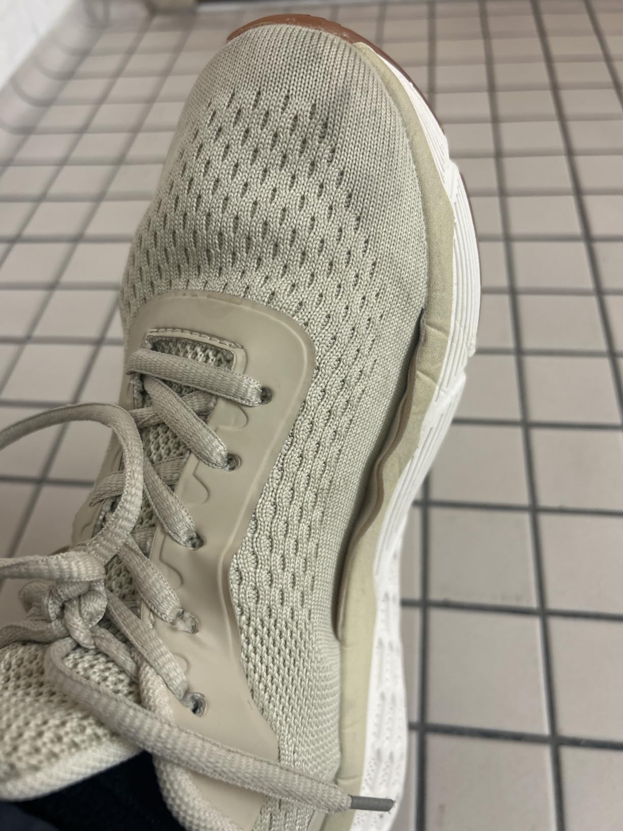 Close-up detail of TSIODFO sneaker showing mesh upper construction and lace-up closure system