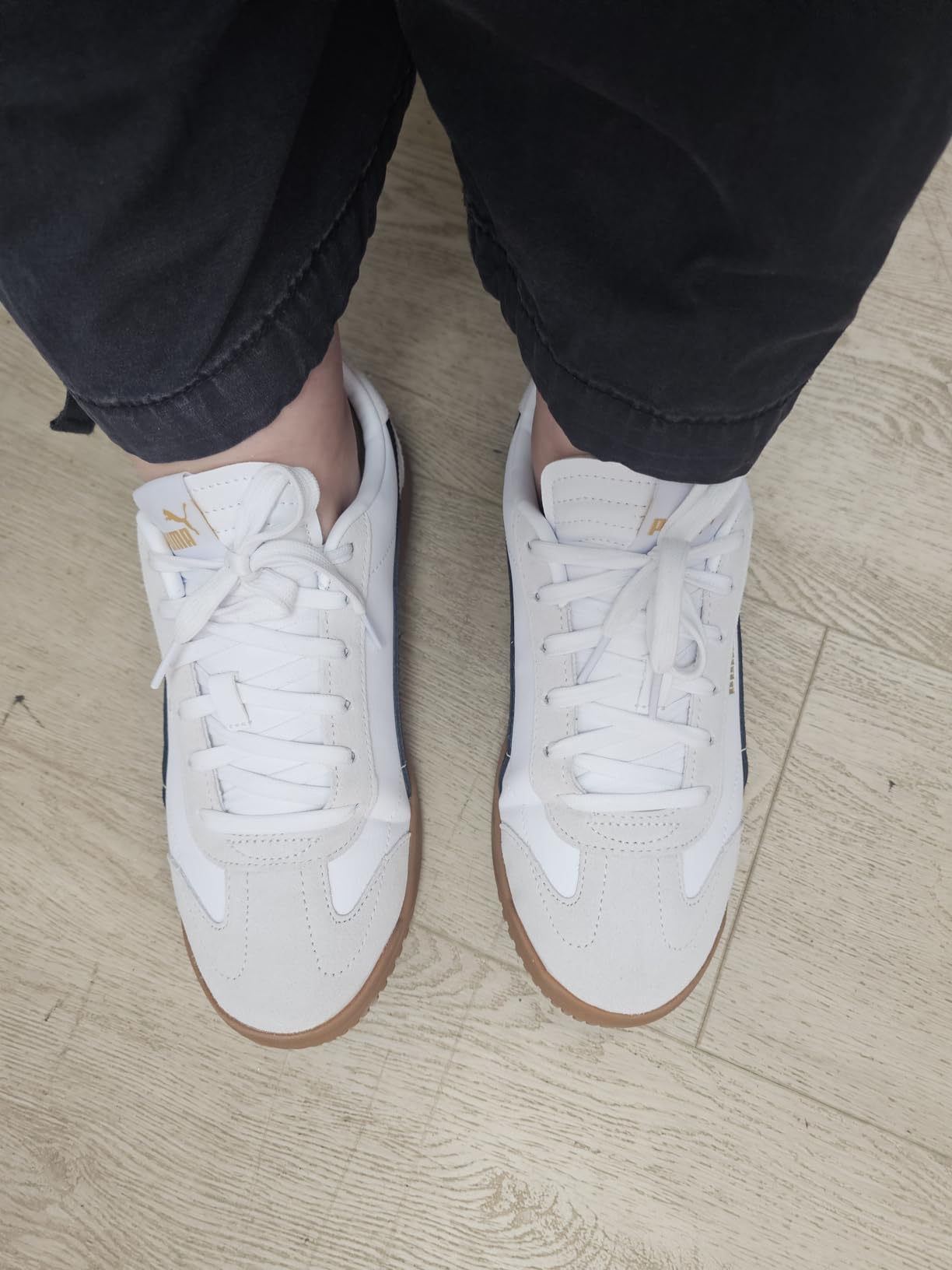 PUMA Club 5v5 detail shot showing coated leather upper with soccer-inspired stitching and gold foil branding