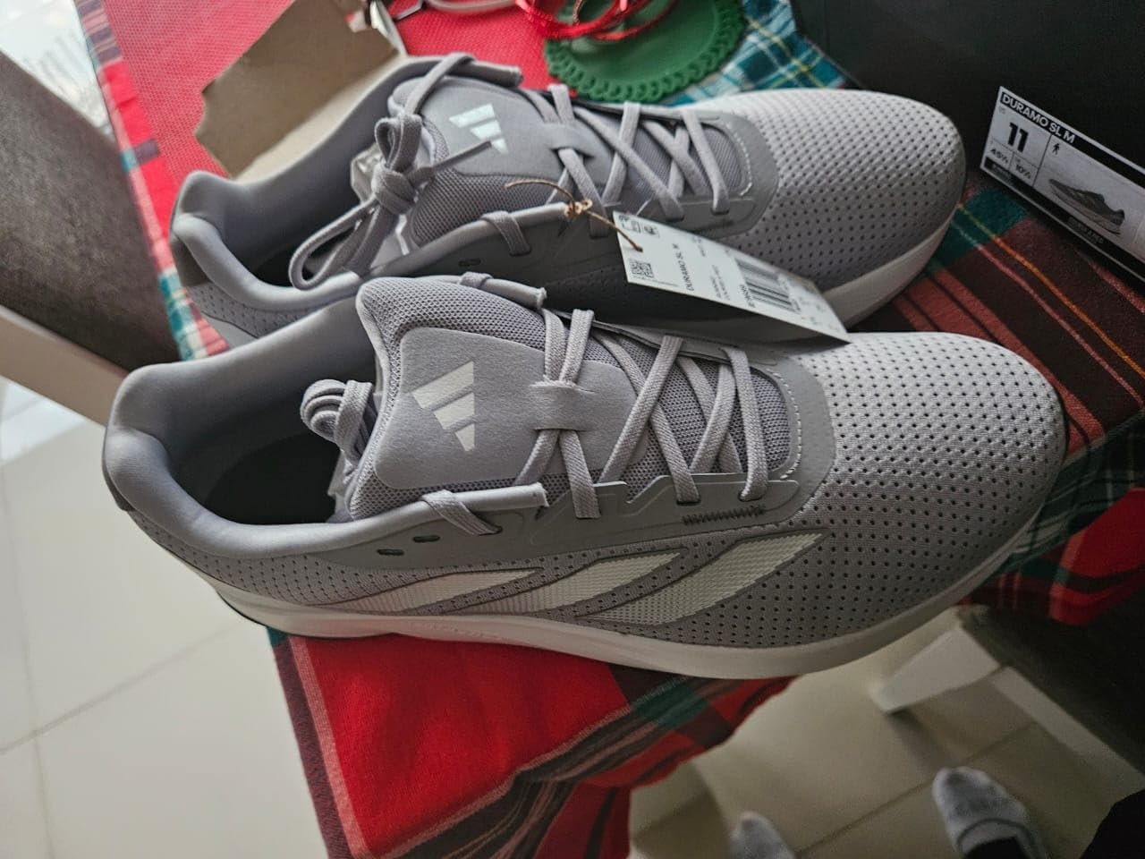 Adidas Duramo SL black running shoe from multiple angles showing design details