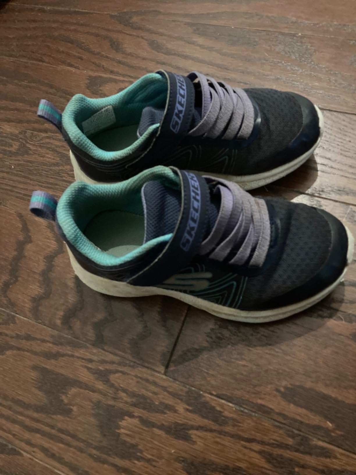 A side view of the Skechers kids sneaker showing the swirl pattern and velcro strap.