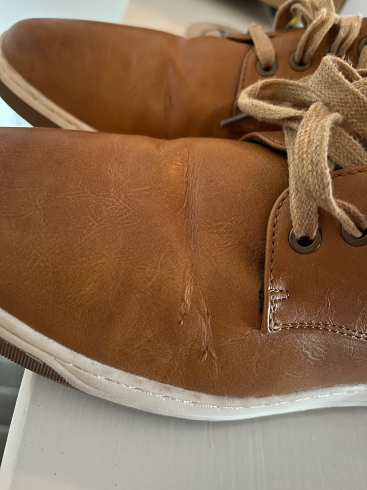 Multiple wear patterns on Jousen dress sneakers showing common failure points after extended use