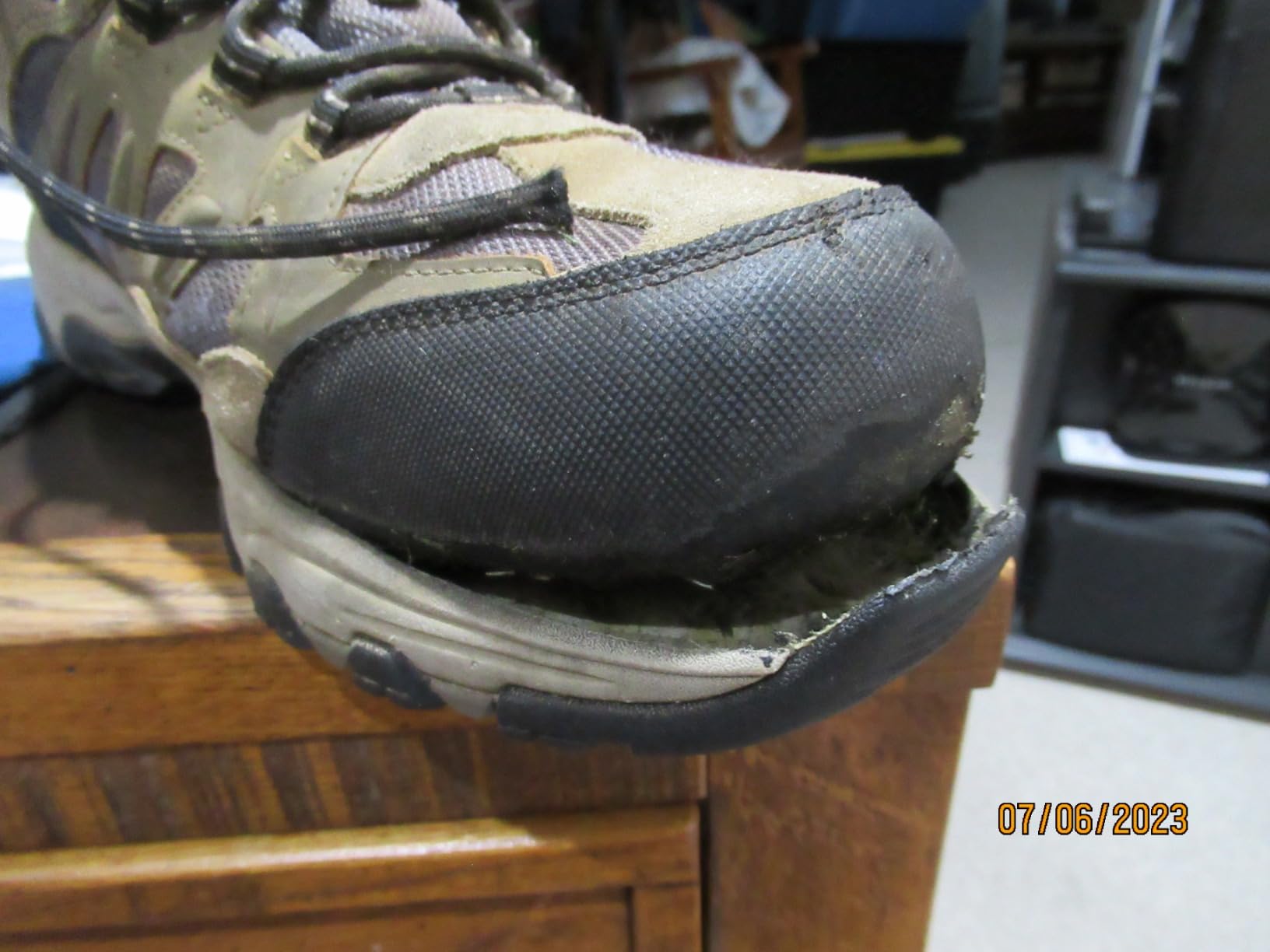 Customer photo showing sole detachment issue after 10 months of dog walking use