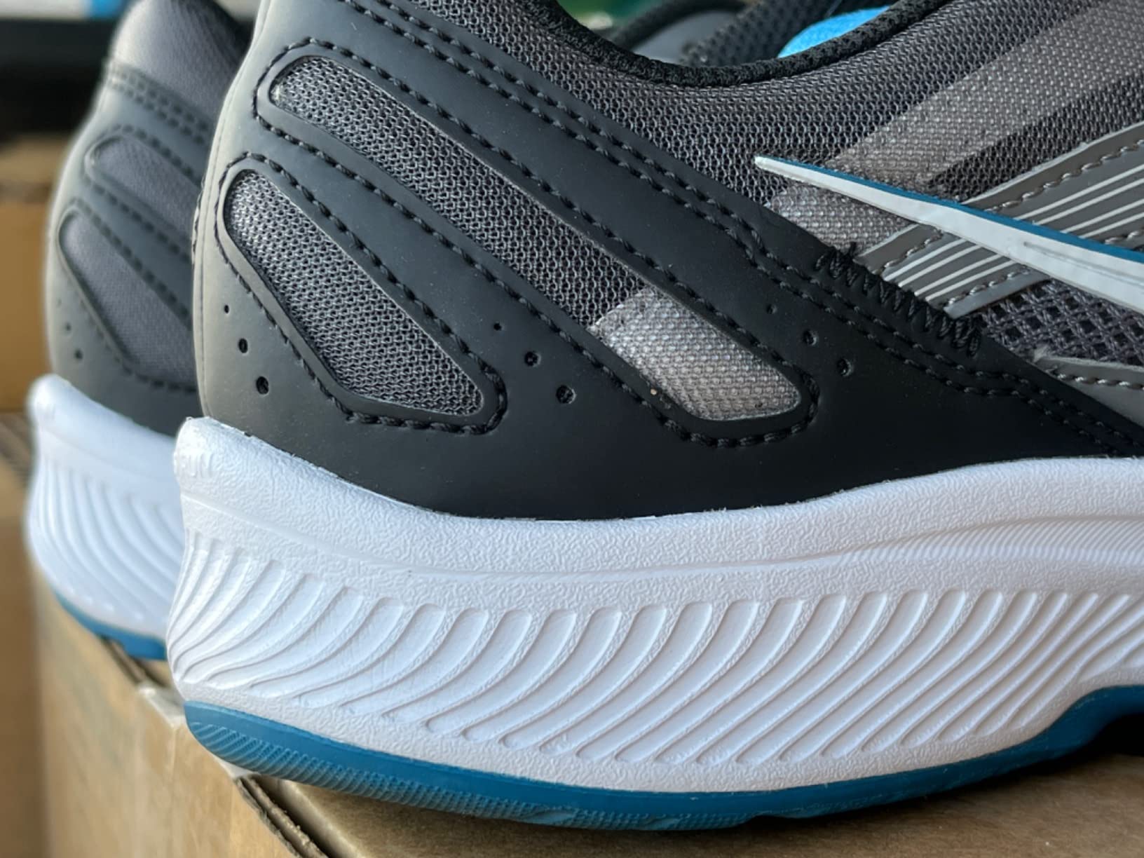 Saucony Cohesion 15 in action during road running showing flexibility and ground contact