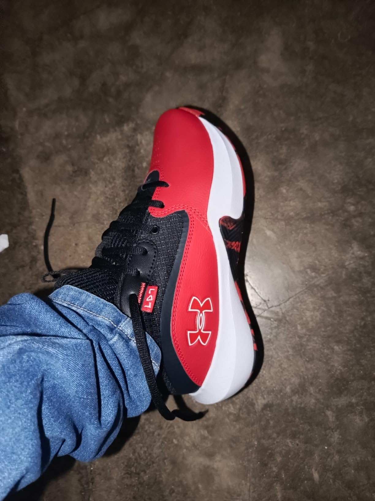 Under Armour Lockdown 7 basketball shoes from side profile showing ankle height and overall silhouette design