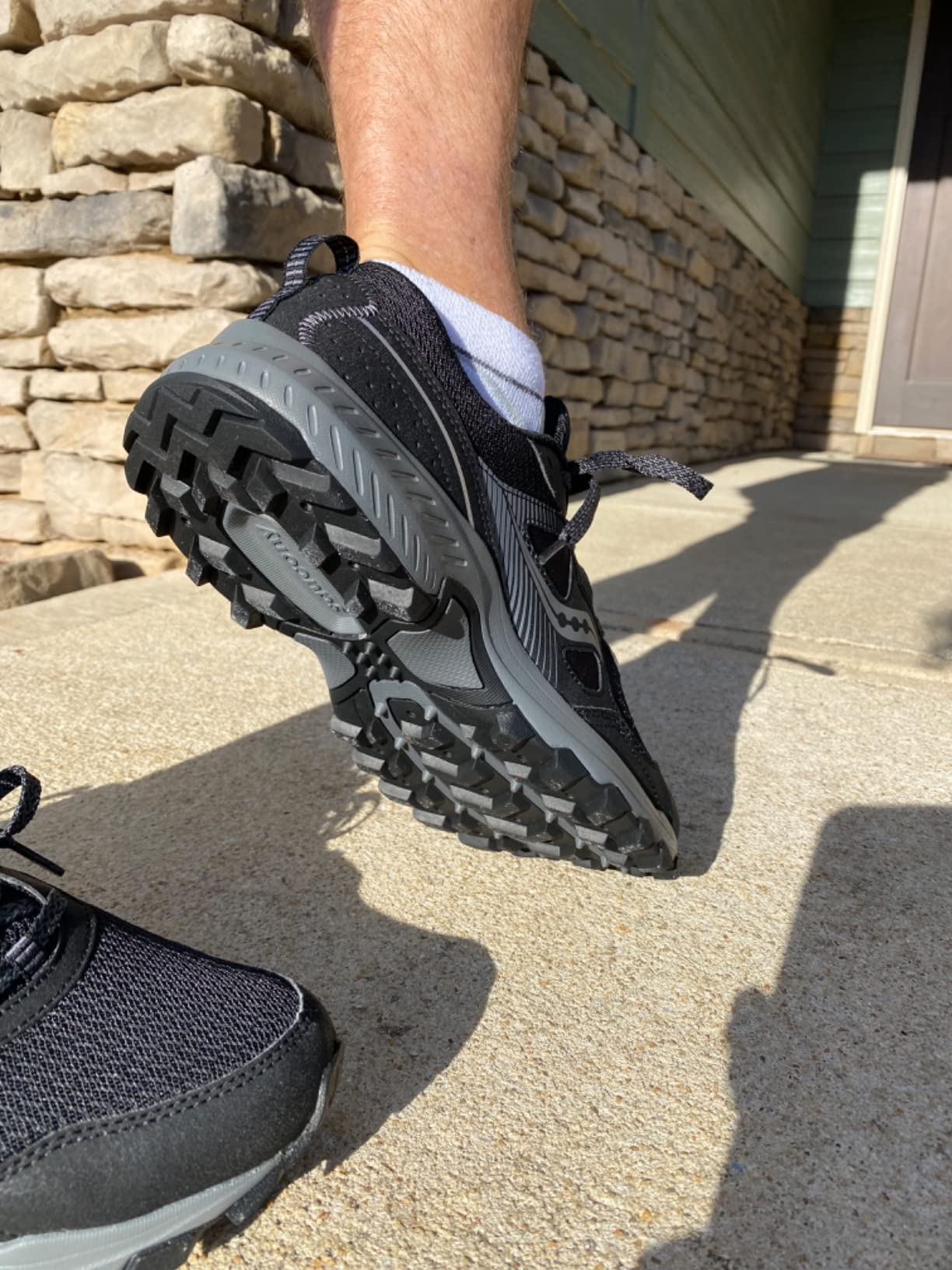 Saucony TR16 action shot during trail running showing flexibility and ground contact
