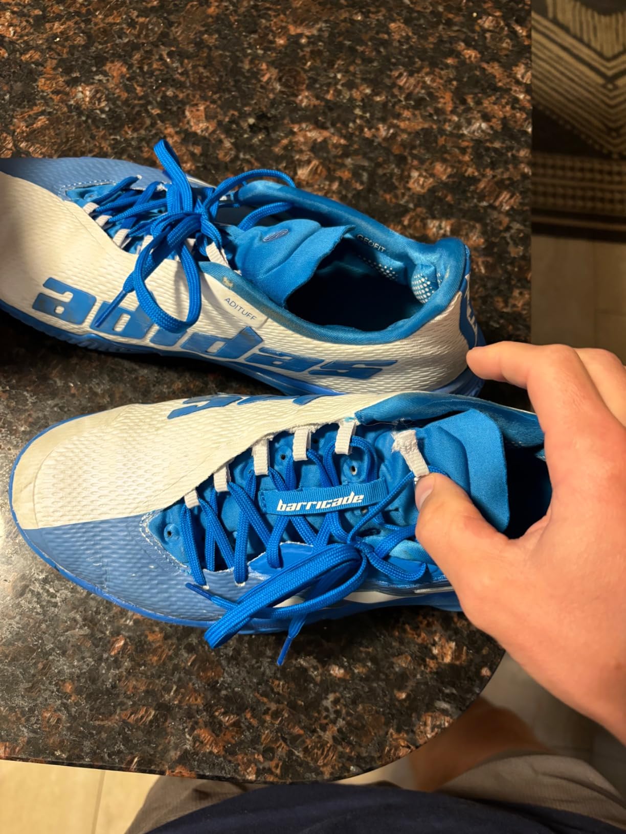 Broken lace loop on Adidas Barricade showing construction weakness in lacing system