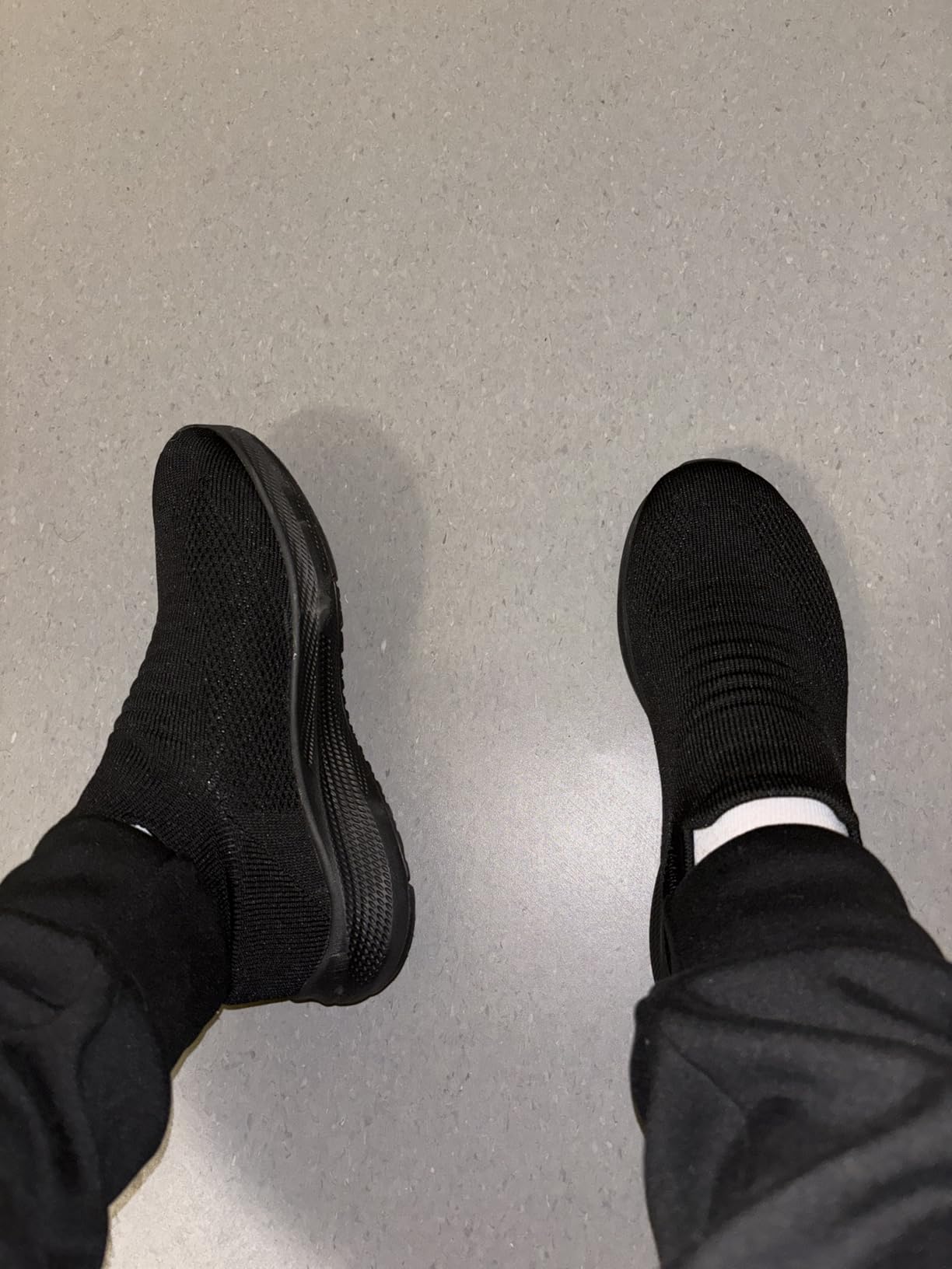 Bottom view of SHULOOK walking shoes showing rubber outsole tread pattern and non-slip design claims