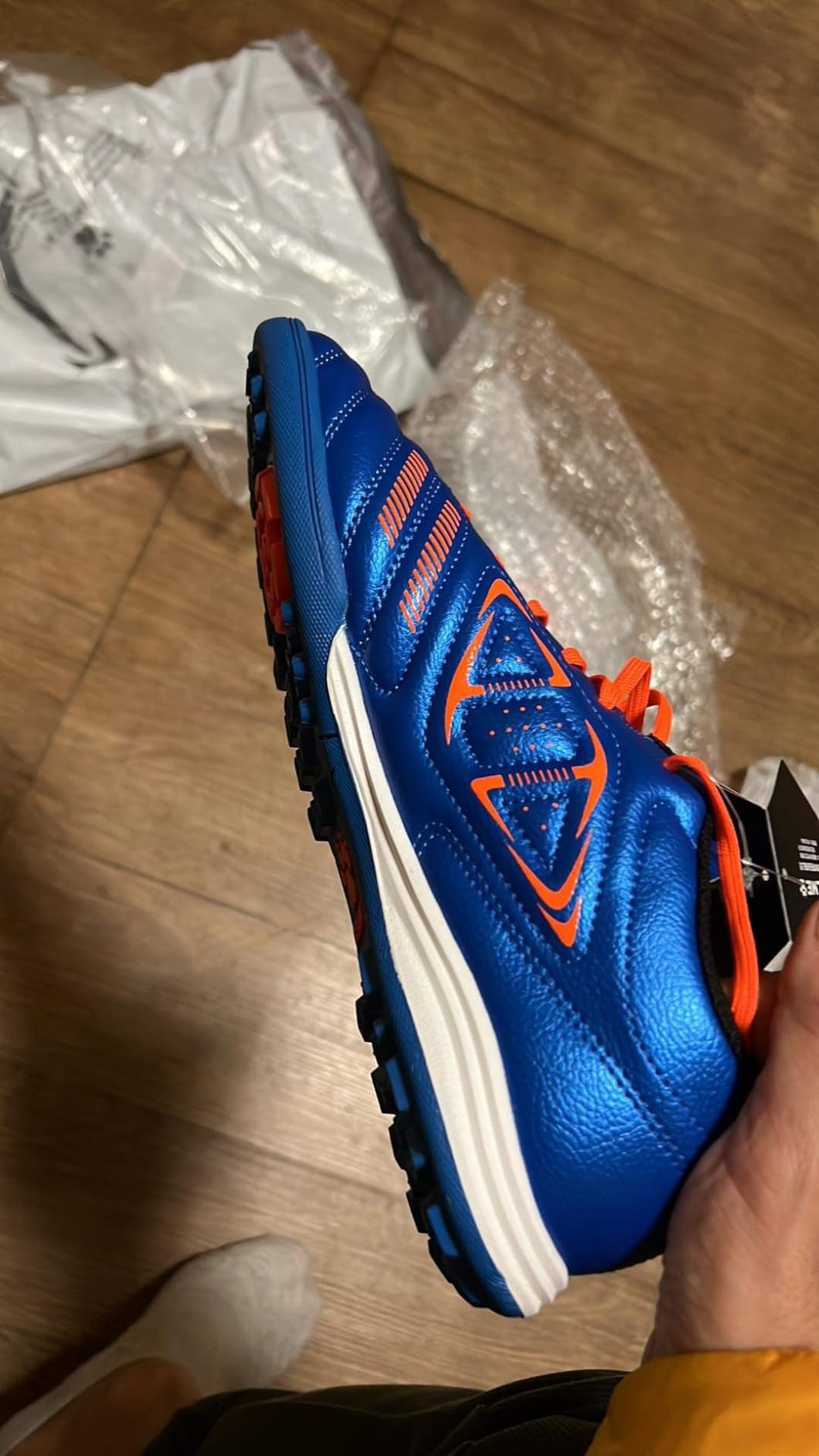 Multiple angle view of KELME soccer cleats showing stud pattern and sole design