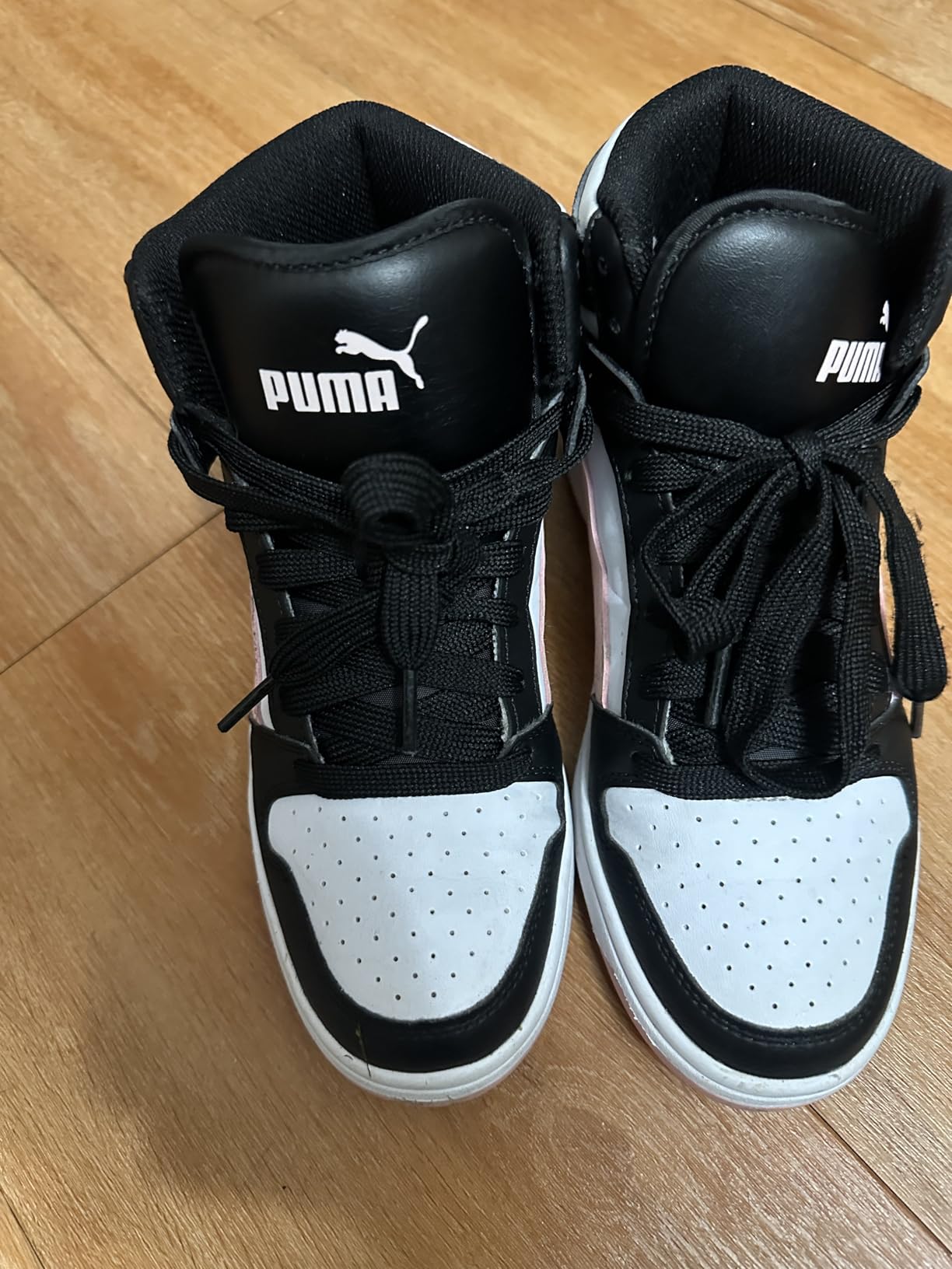 PUMA Rebound Layup Mid kids sneakers on basketball court showing performance capability