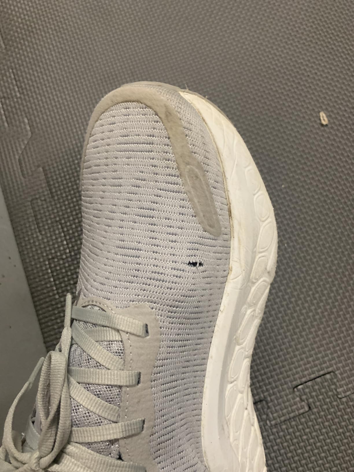 Close-up of New Balance Kaiha mesh upper showing fabric deterioration and holes