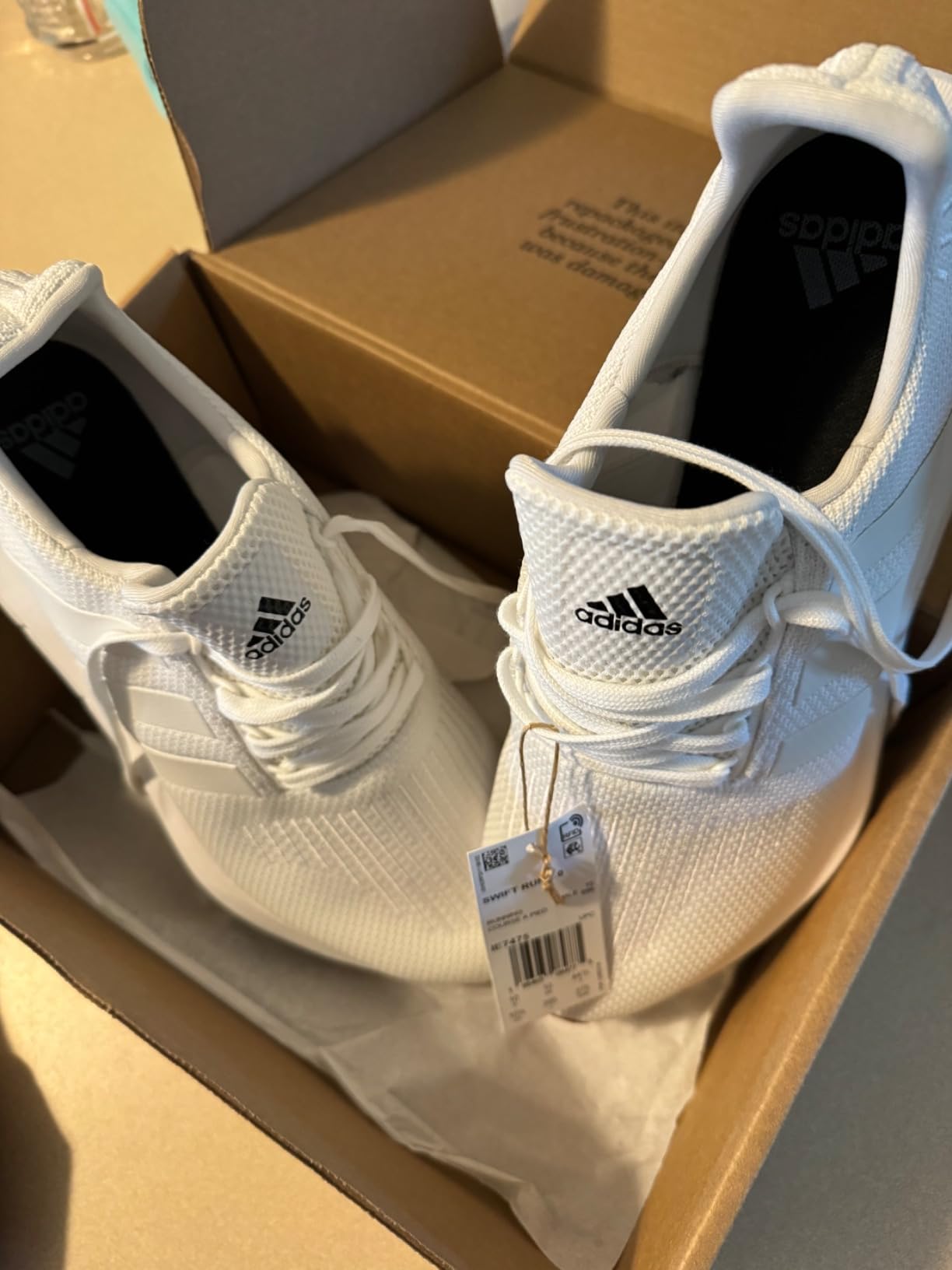 Adidas Swift Run sneakers being worn in real-world setting showing practical daily use