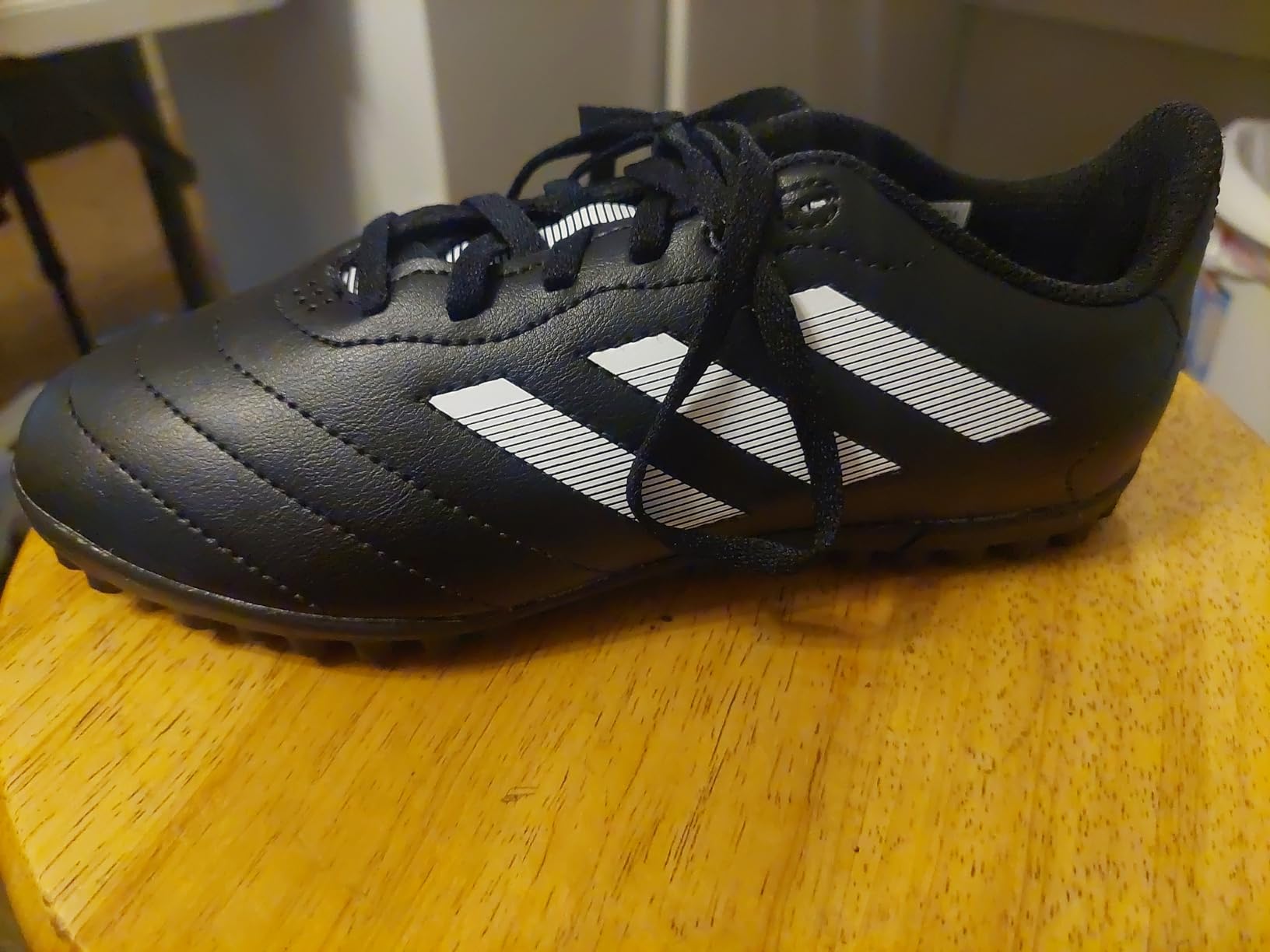 Bottom view of adidas Kids Goletto showing turf-specific rubber outsole with multi-directional lugs