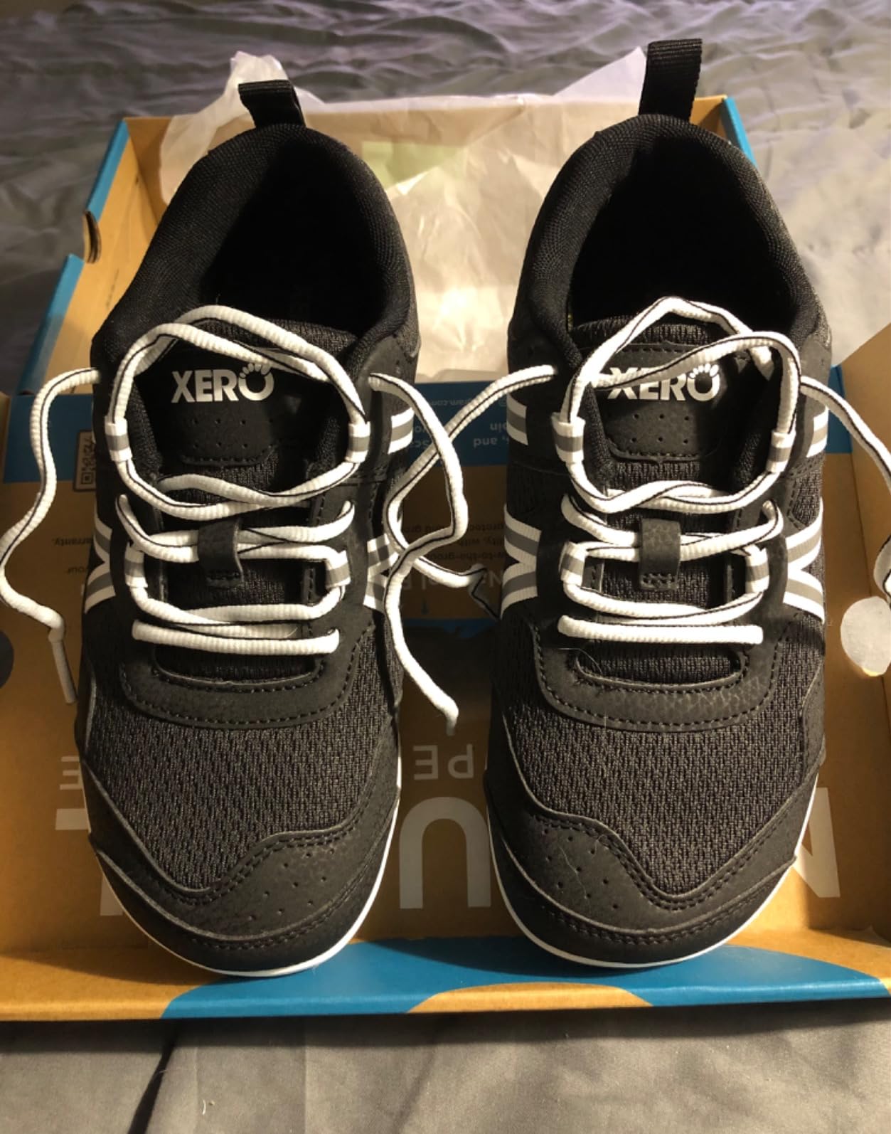 Detail shot of Xero Prio lacing system and heel strap design showing secure fit features