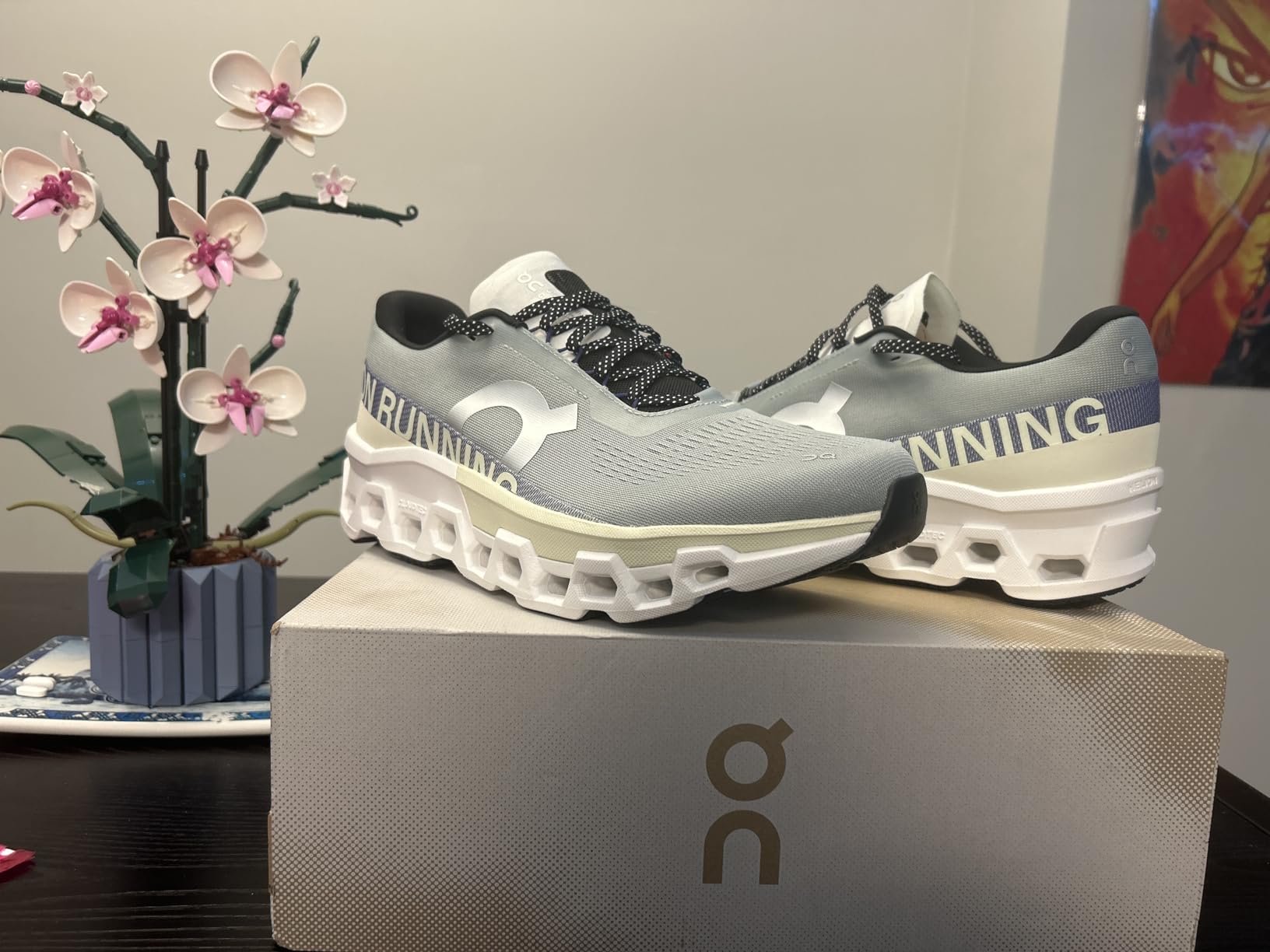 On Men's Cloudmonster sneakers showing distinctive CloudTec cushioning system and mesh upper design