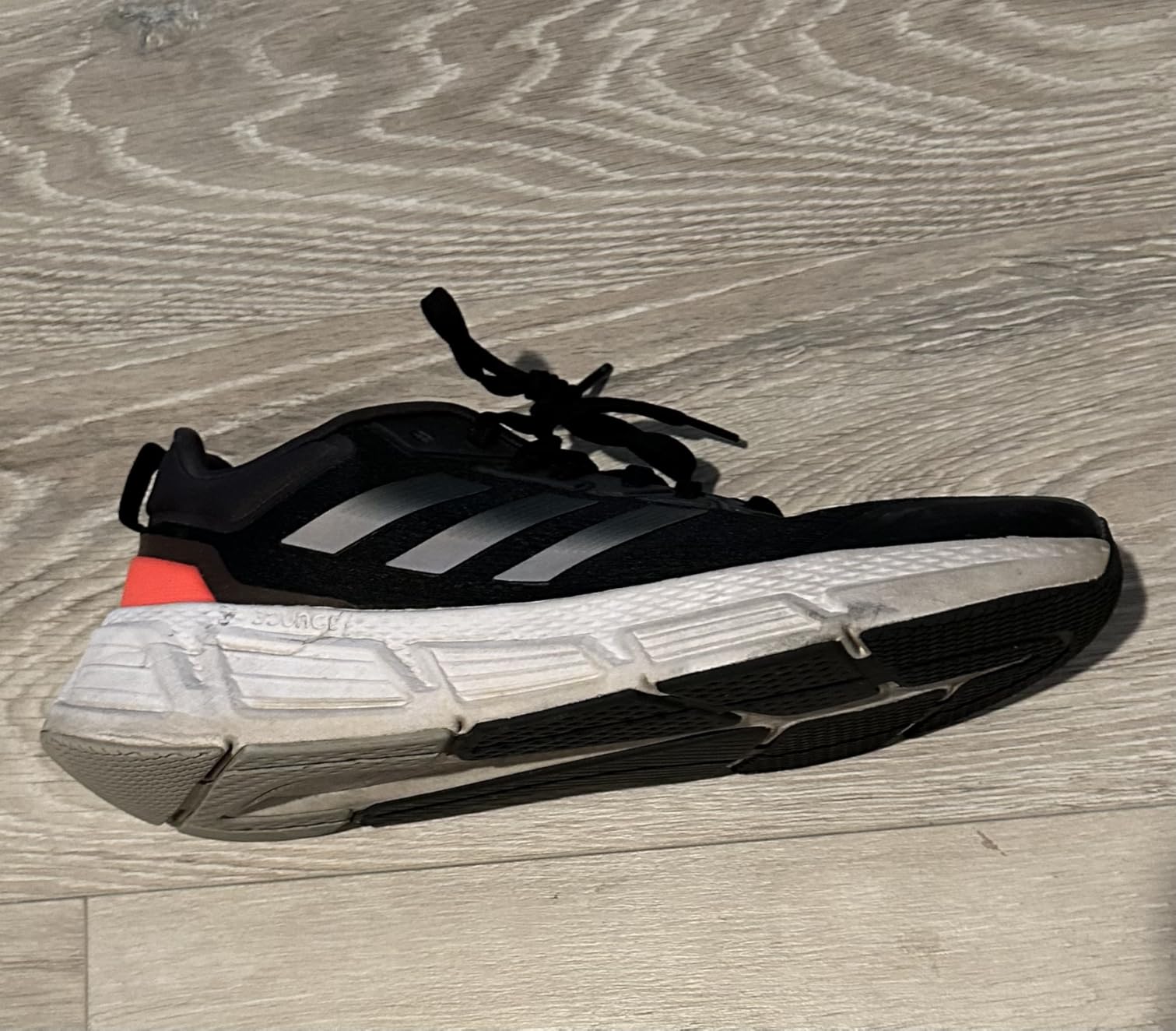 Adidas Questar side angle showing cushioning compression during use