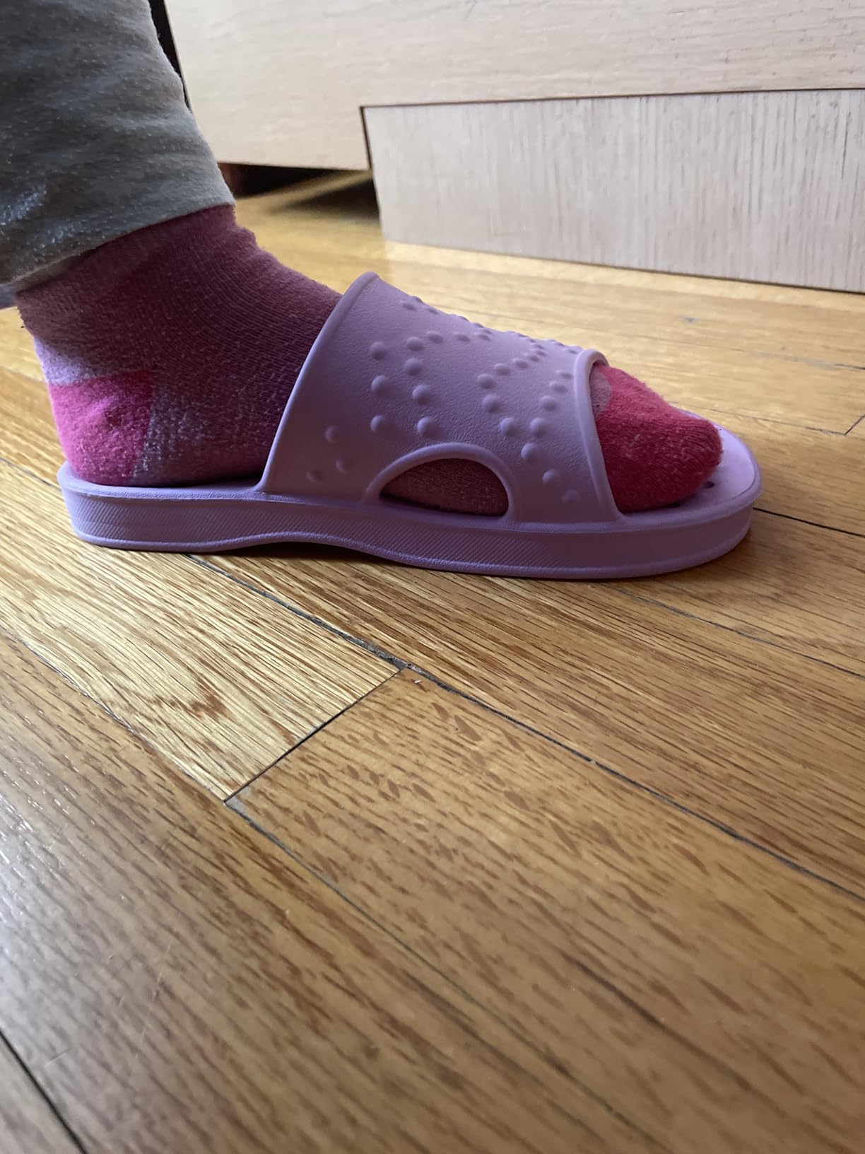Close-up of shevalues shower shoes showing drain hole pattern and EVA construction