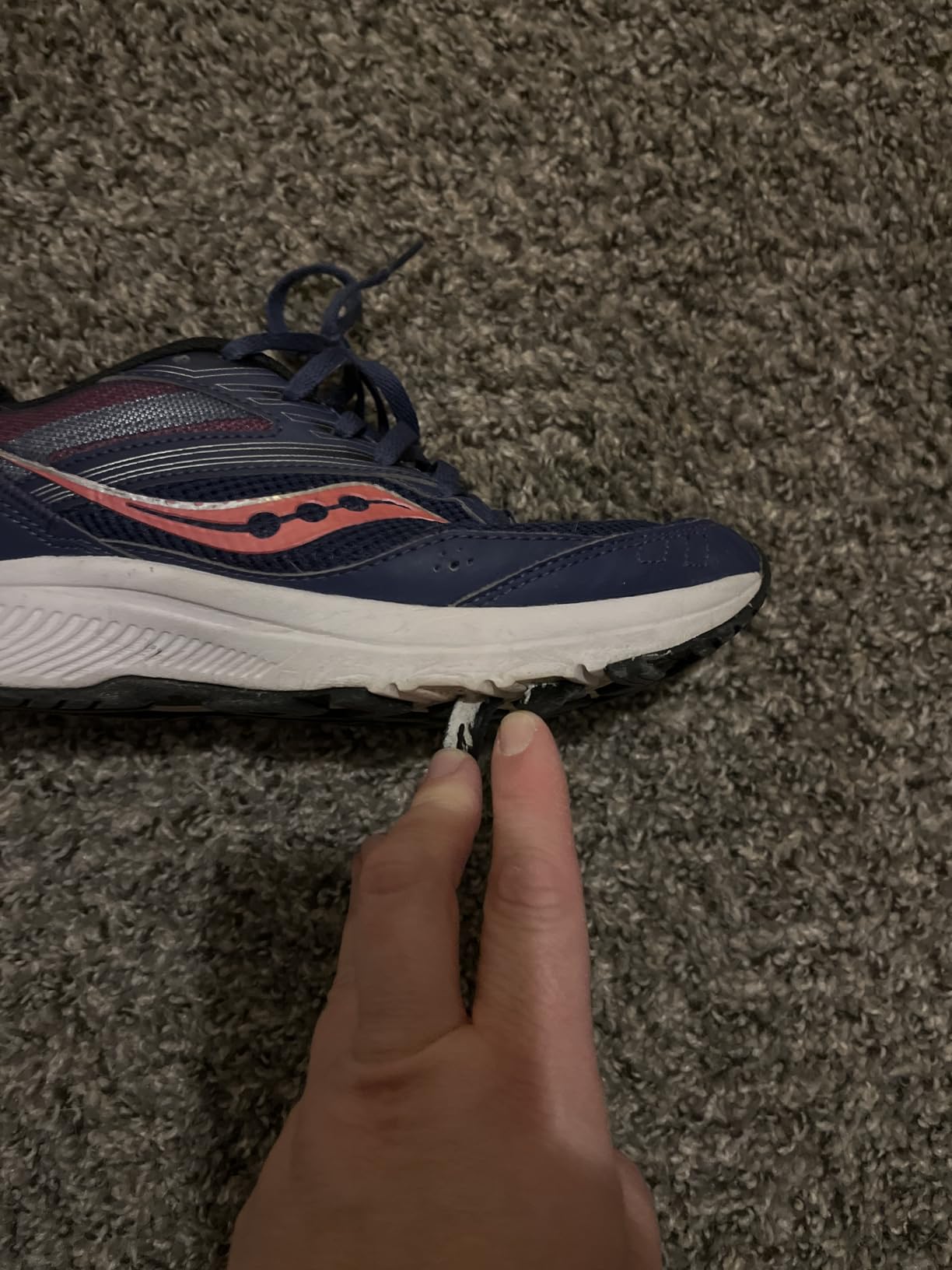 Close-up of sole separation issue on Saucony Cohesion 15 showing durability concerns after regular use