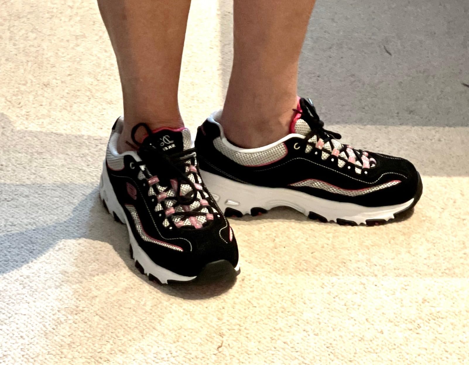 A woman wearing Skechers D'Lites, showing how they look as part of a casual outfit.