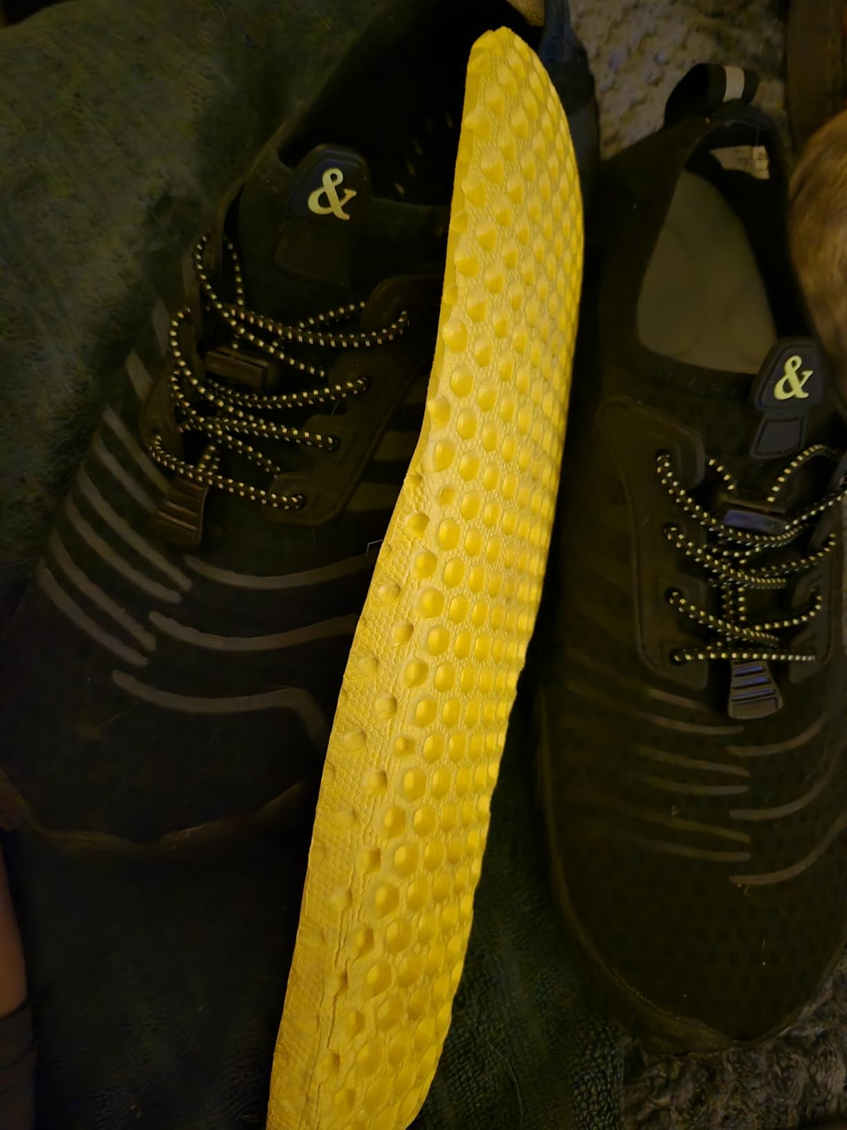 Bottom view of sole showing detailed drainage hole pattern and grip texture
