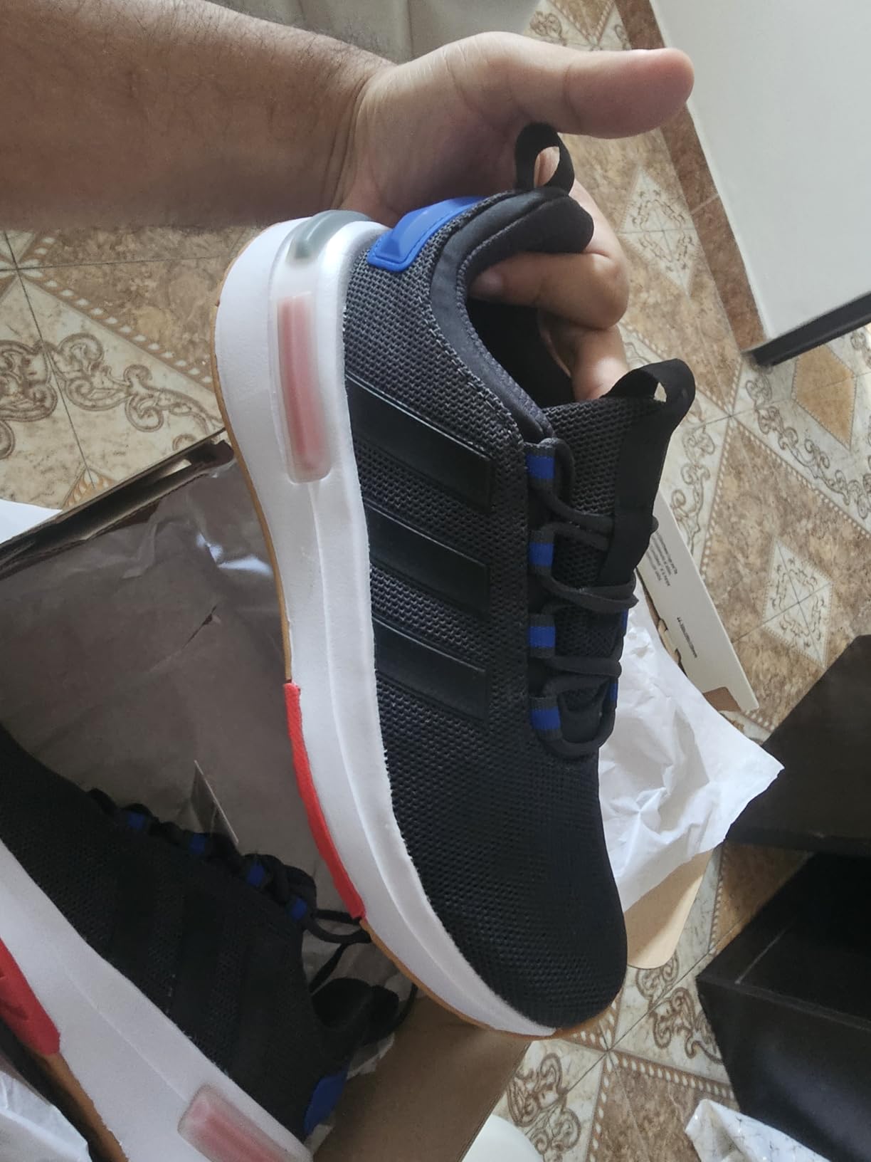 Detailed close-up of Adidas Racer TR23 construction showing quality of stitching and material assembly