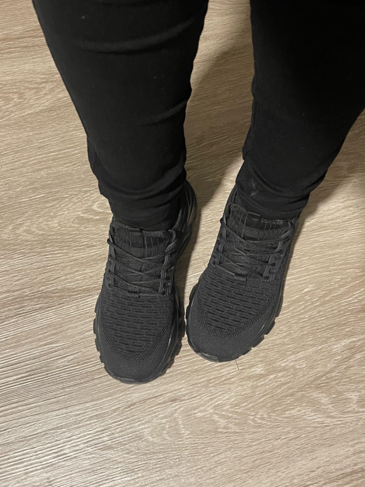 Full outfit shot showing sneakers styled with casual jeans and athletic wear