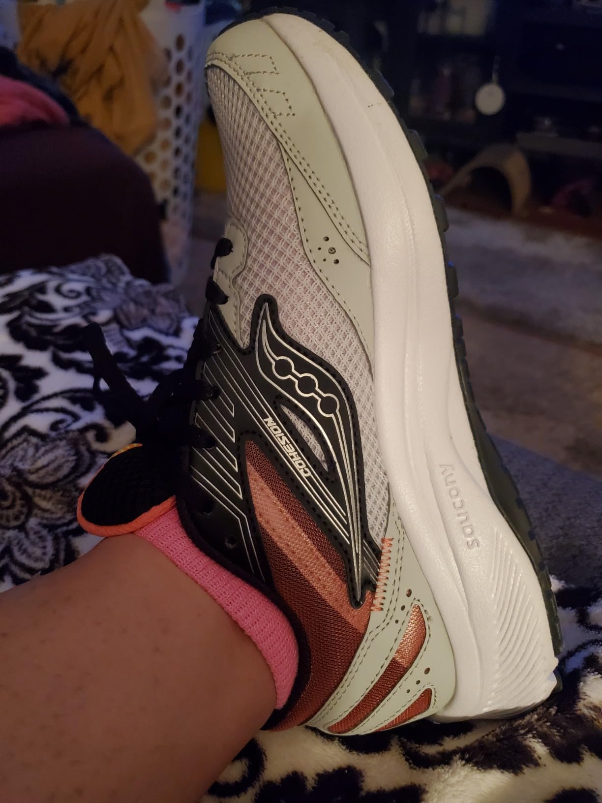 Close-up detail of Saucony Cohesion 15 showing breathable mesh upper construction and synthetic overlay design