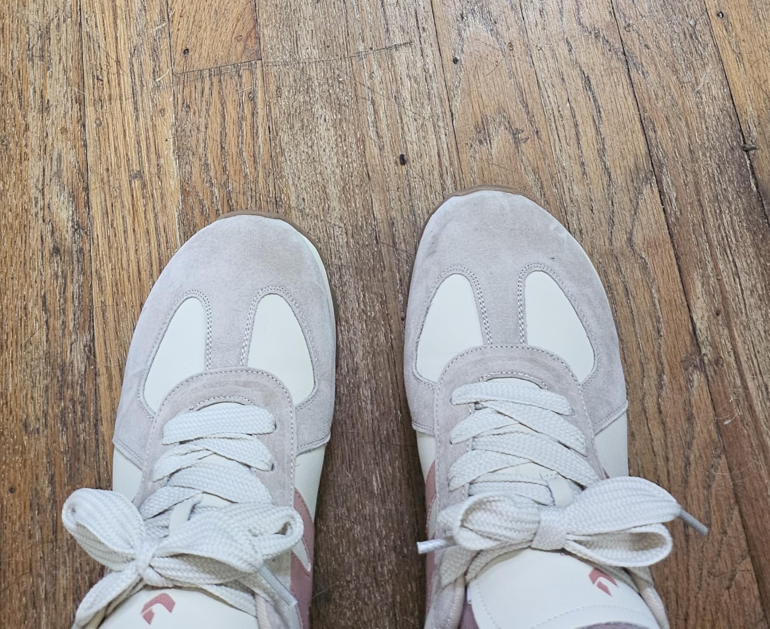 SOMILISS sneakers worn showing pink and cream colorway in real-world setting