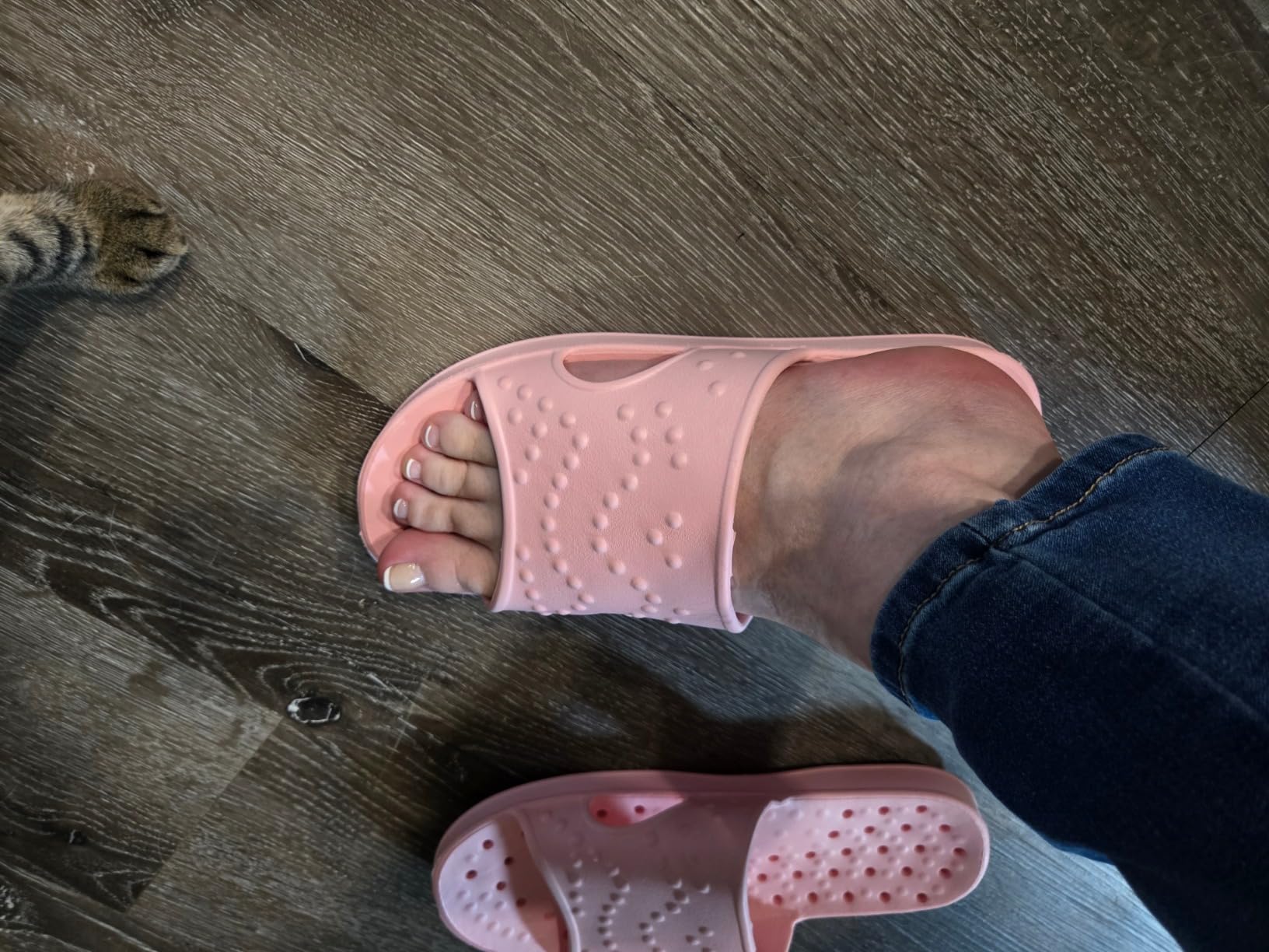 Pair of shevalues shower shoes on pool deck showing water drainage
