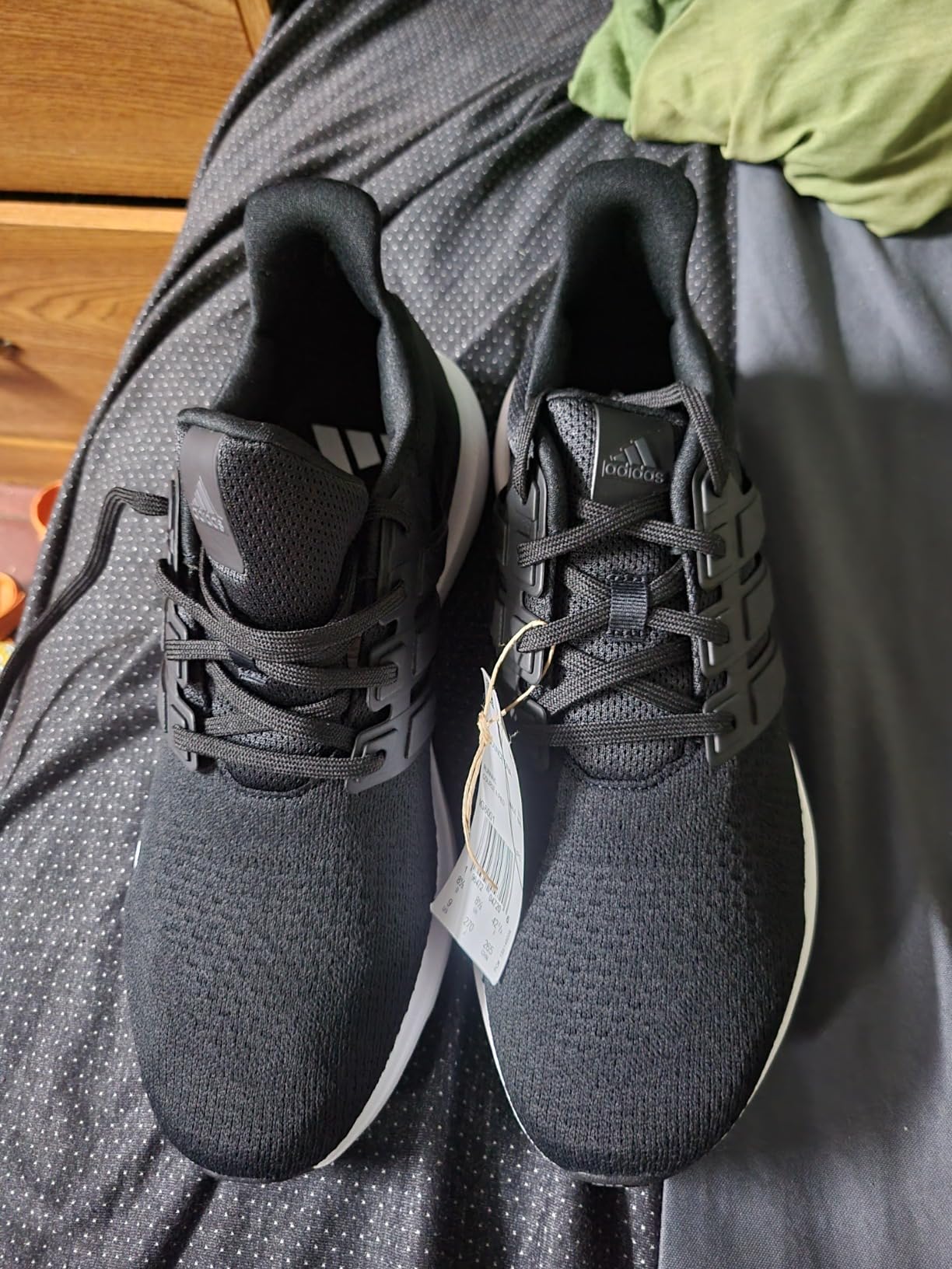 Close-up view of Adidas Ubounce DNA showing TPU cage structure and knit upper material details