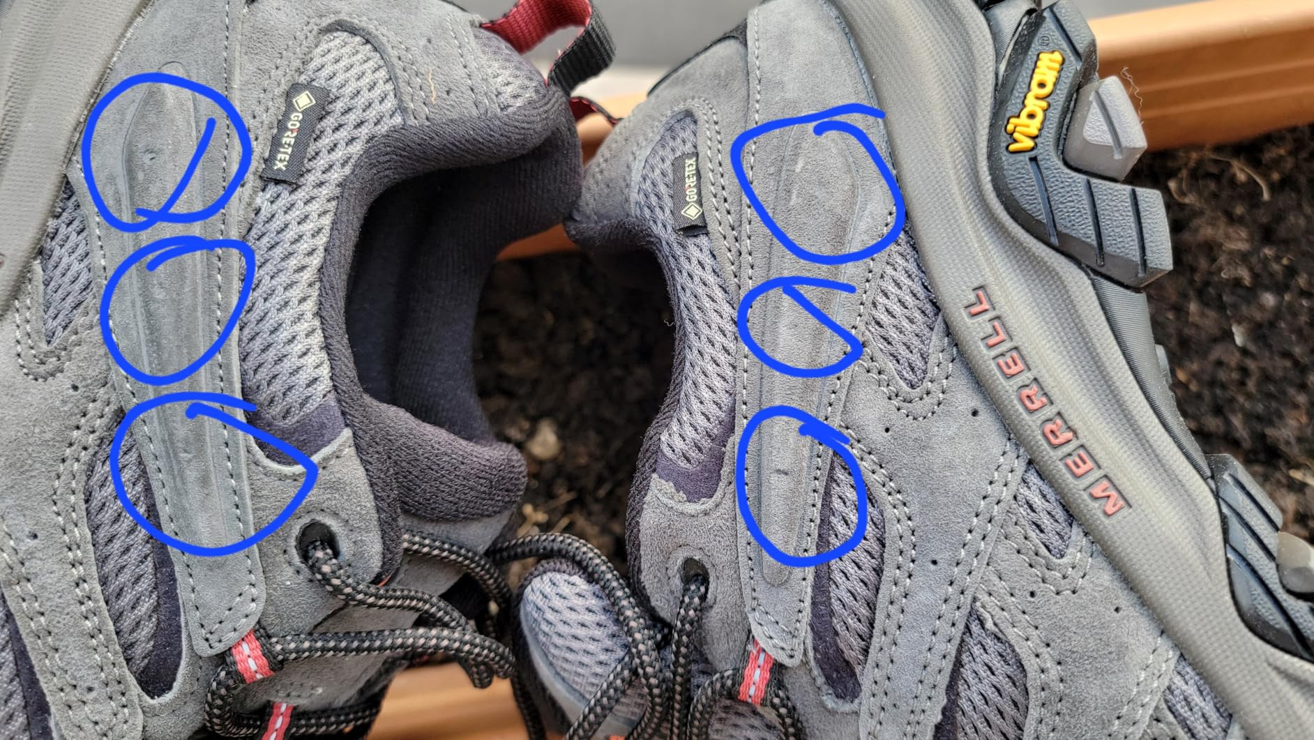 Defective Merrell boot showing quality control issues with construction defects
