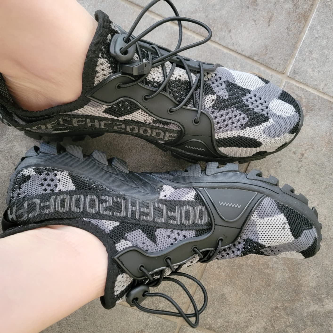 Close-up view of TANGYUGEN water shoes showing knit mesh upper construction and elastic lacing system