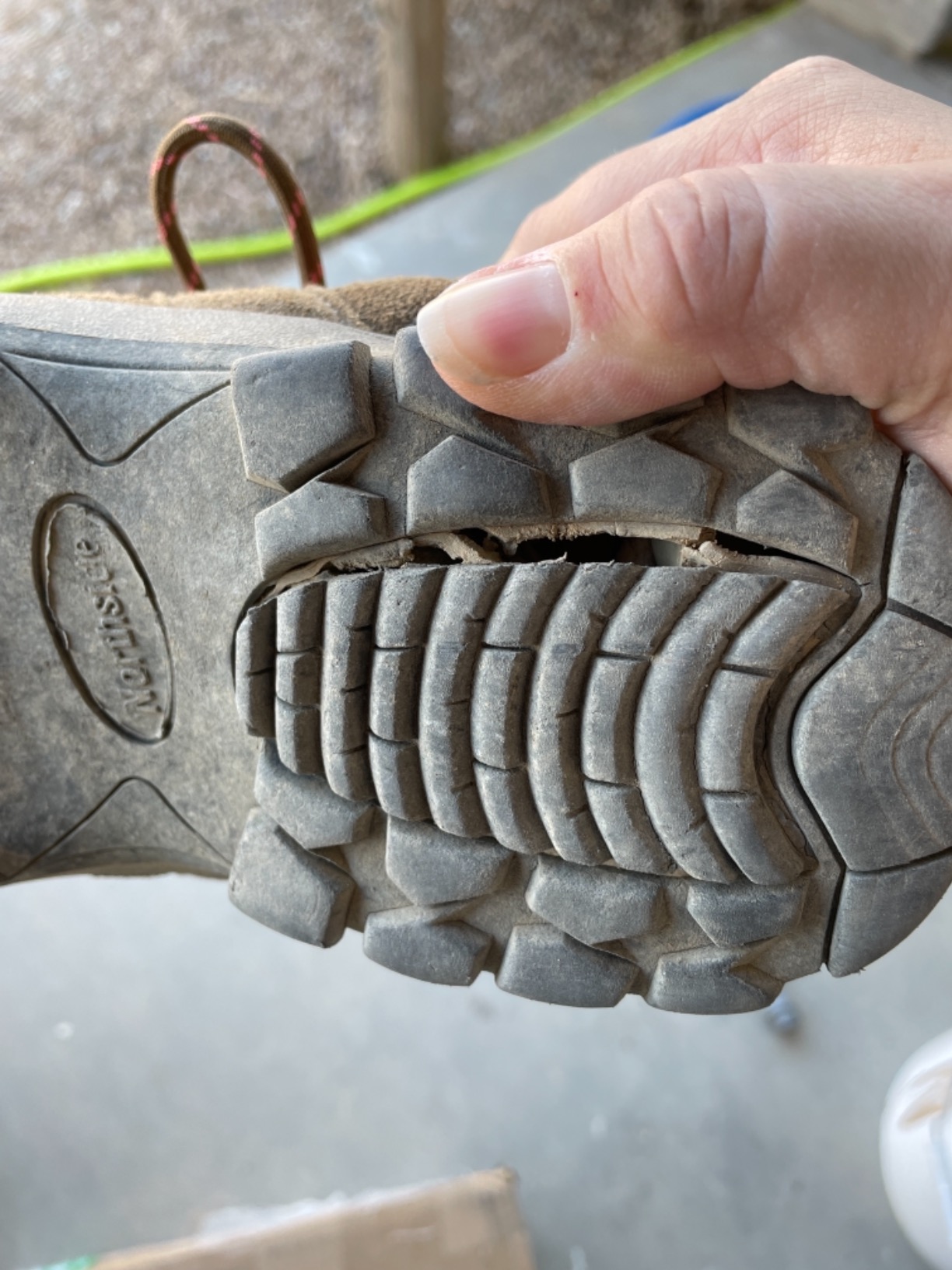 Detailed view of sole separation and construction issues in Northside Monroe hiking shoe