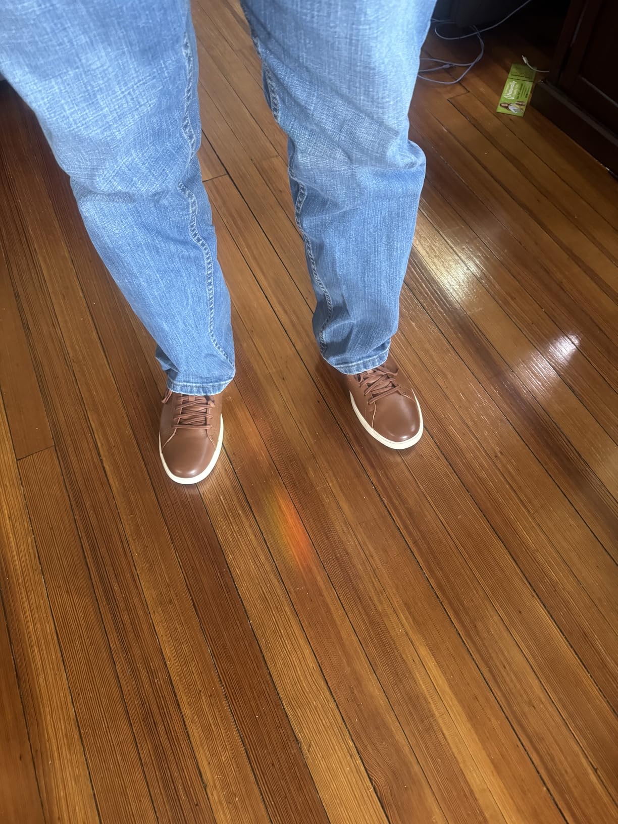 Cole Haan sneakers being worn showing real-world usage and leather aging