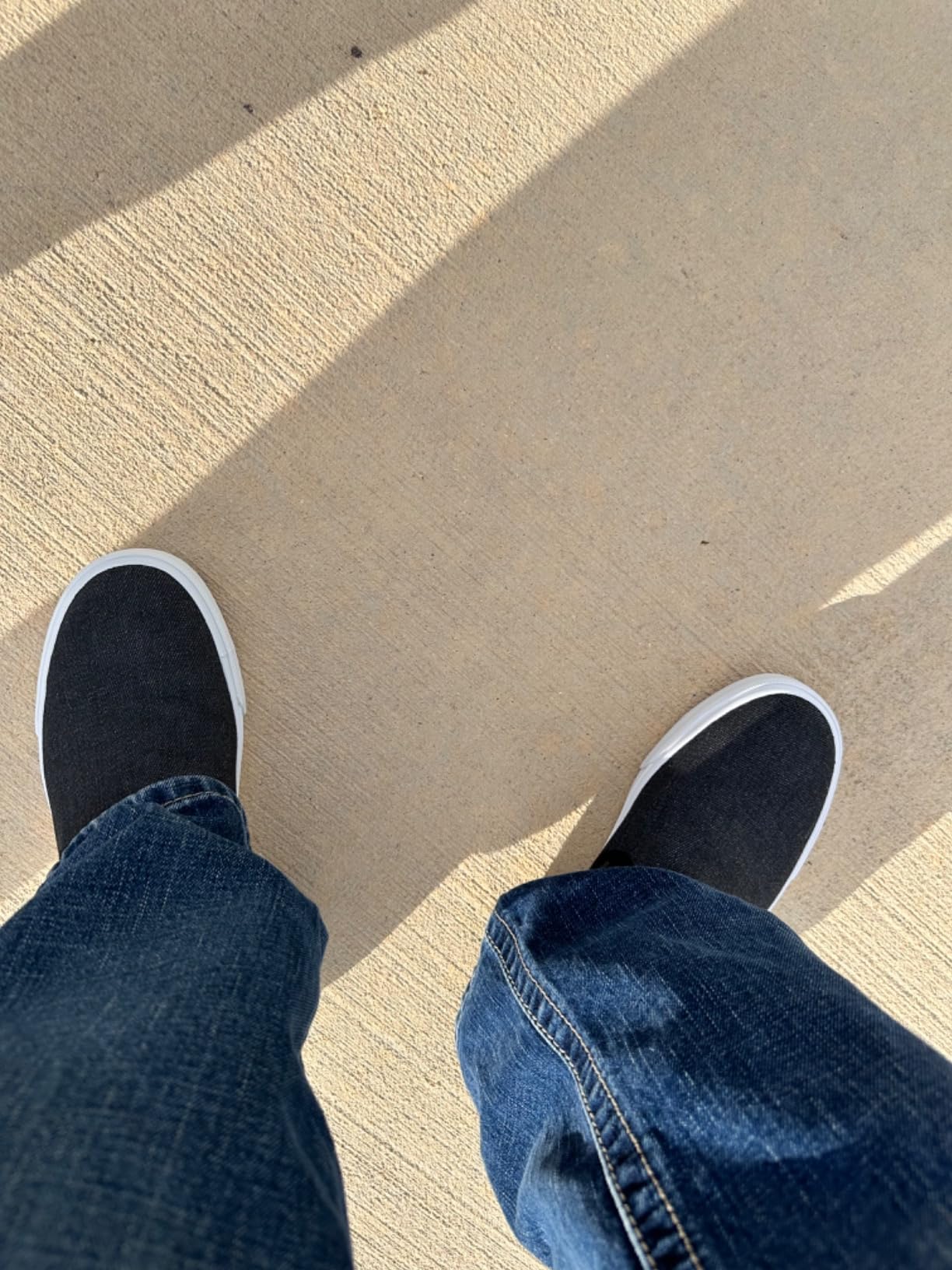 Slip-on canvas sneakers on feet showing the relaxed fit and casual styling for daily wear