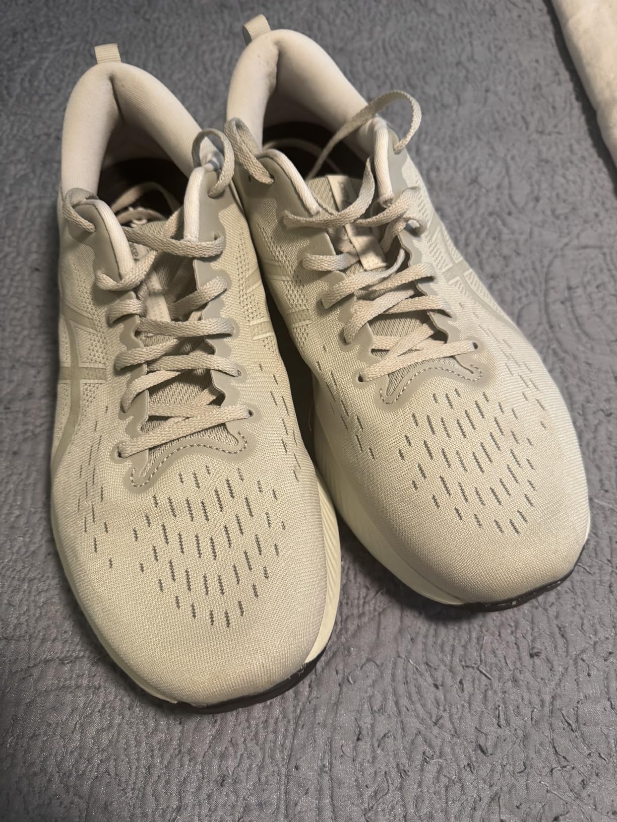Bottom view of ASICS Gel-Excite 10 showing rubber outsole pattern and GEL technology placement
