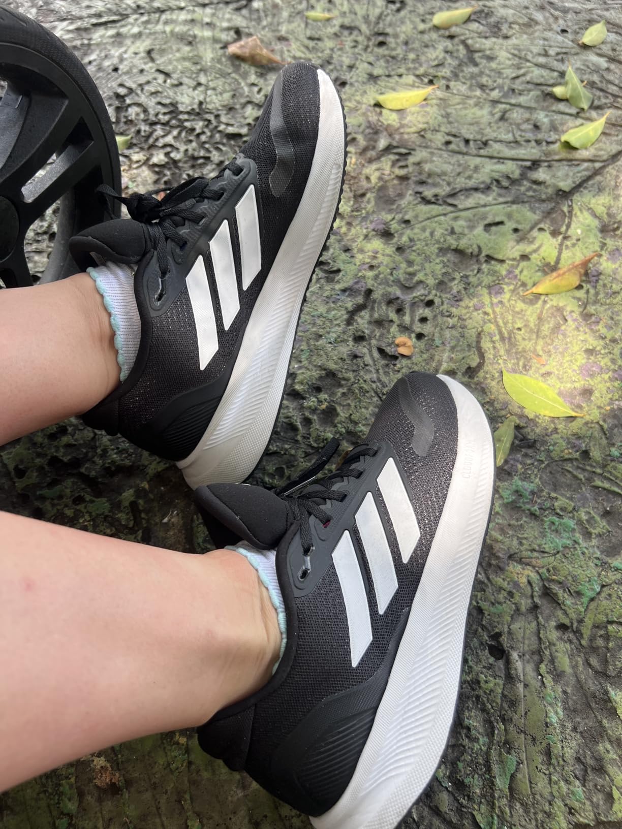 Adidas Women's Run Falcon 5 sneaker showing white mesh upper with black three stripes and cloudfoam midsole technology