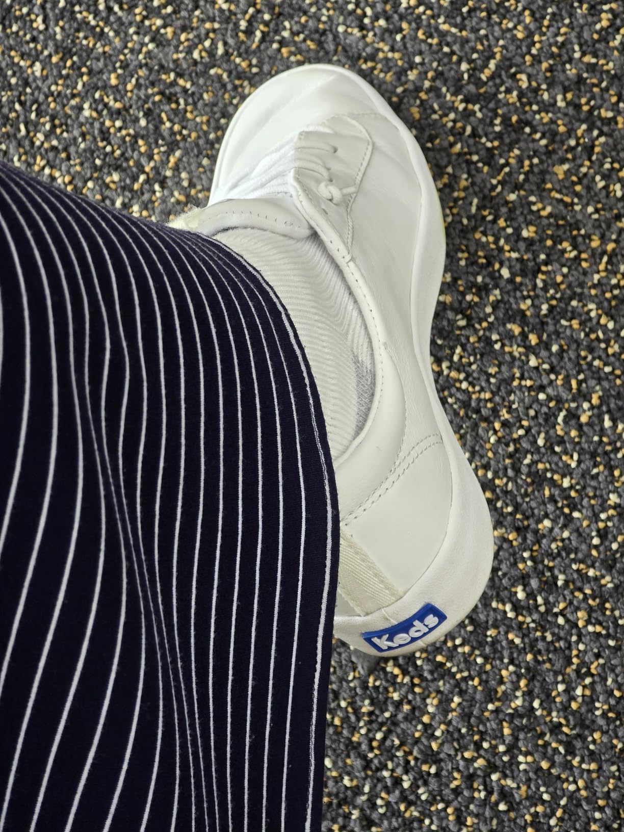 Close-up detail of Keds Kickback slip-on design showing embroidered eyelets and stretch gore construction