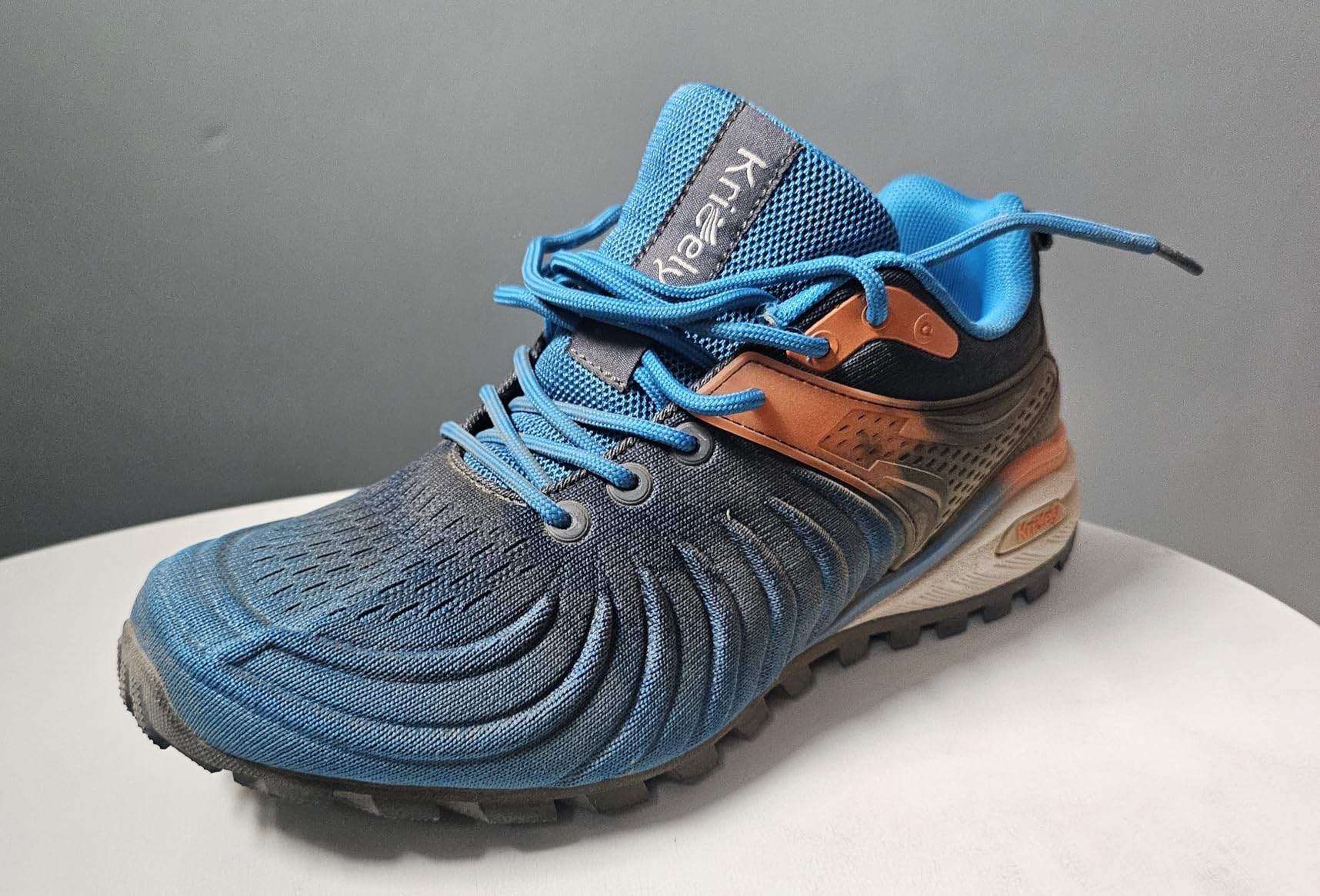 Side profile of Kricely men's walking shoes displaying colorful gradient design and supportive structure