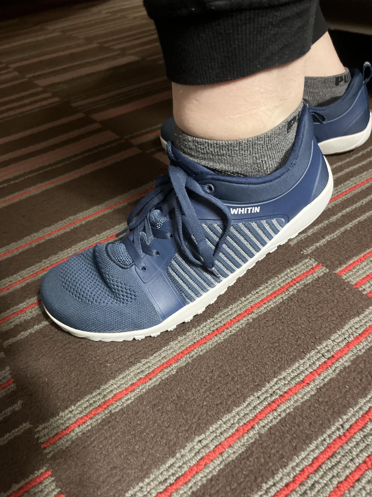 WHITIN trail shoe side view showing mesh upper construction and TPU overlay reinforcements