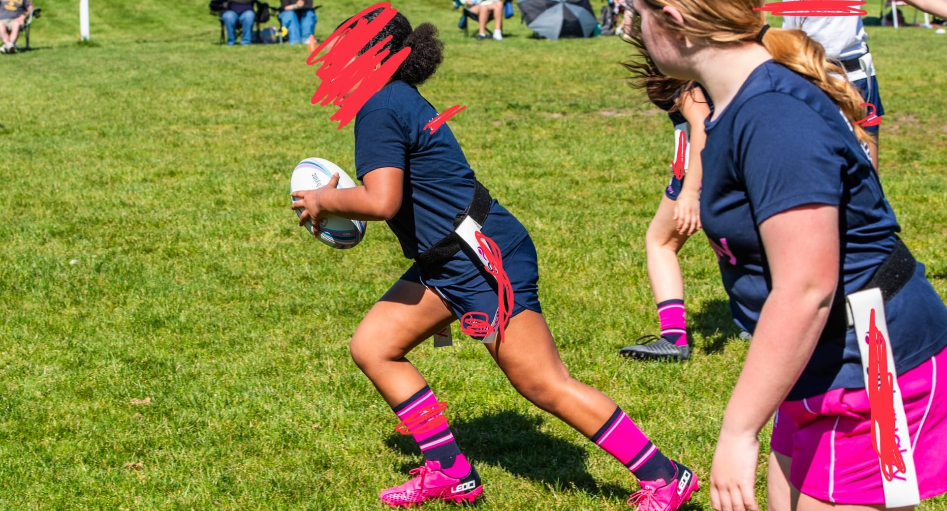 Pink soccer cleats on field showing traction pattern and field performance