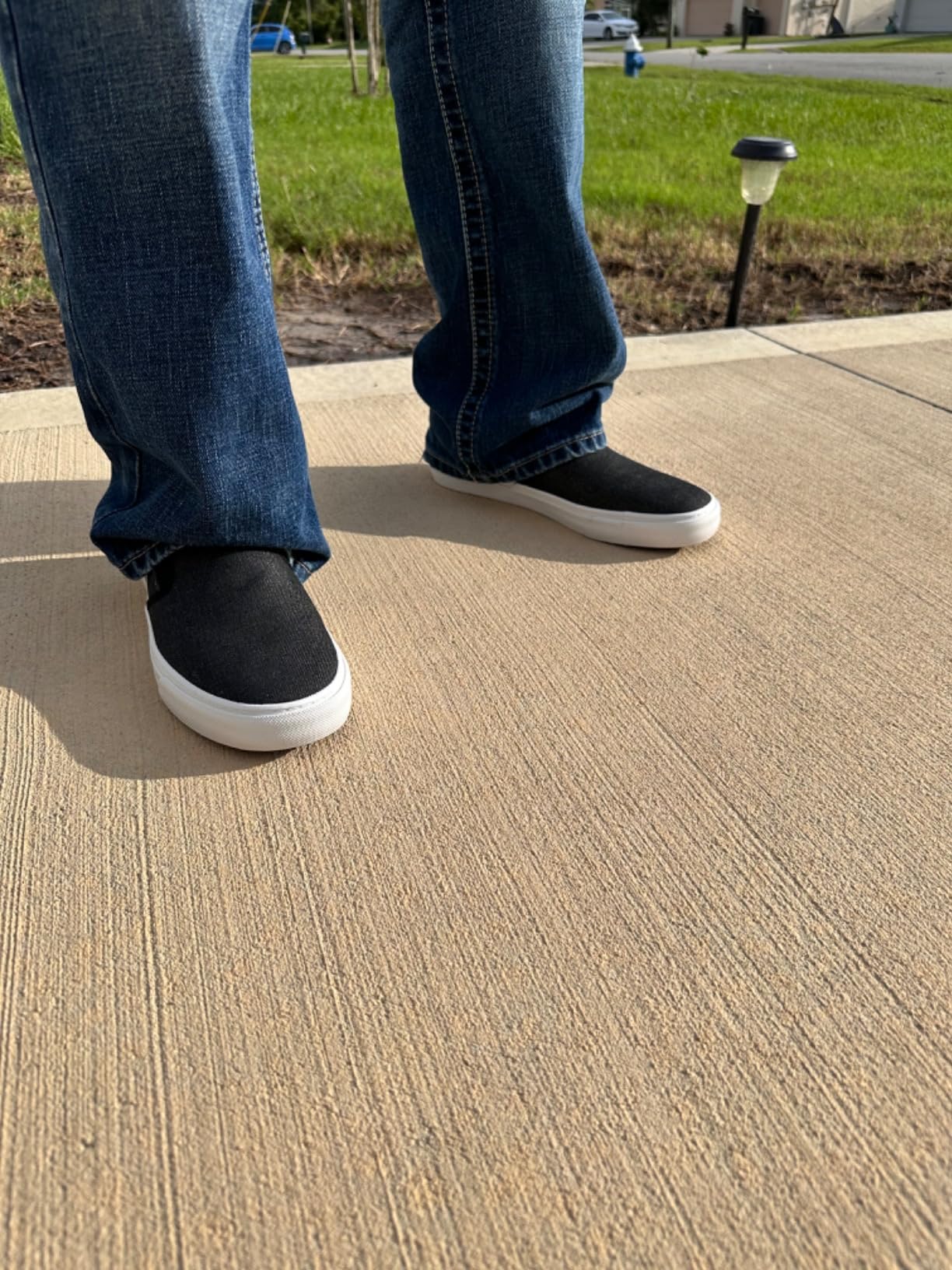 Men's slip-on canvas sneakers product shot showing olive colorway and classic low-profile design