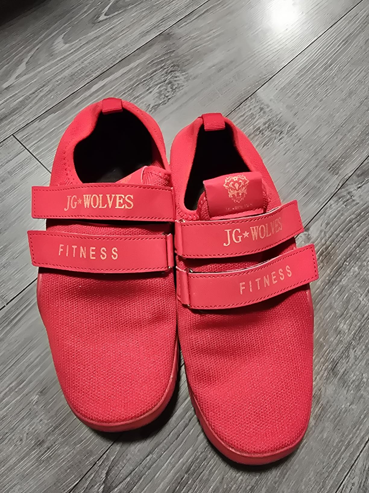 Close-up view of pink deadlift shoes showing flexible upper material and velcro strap system