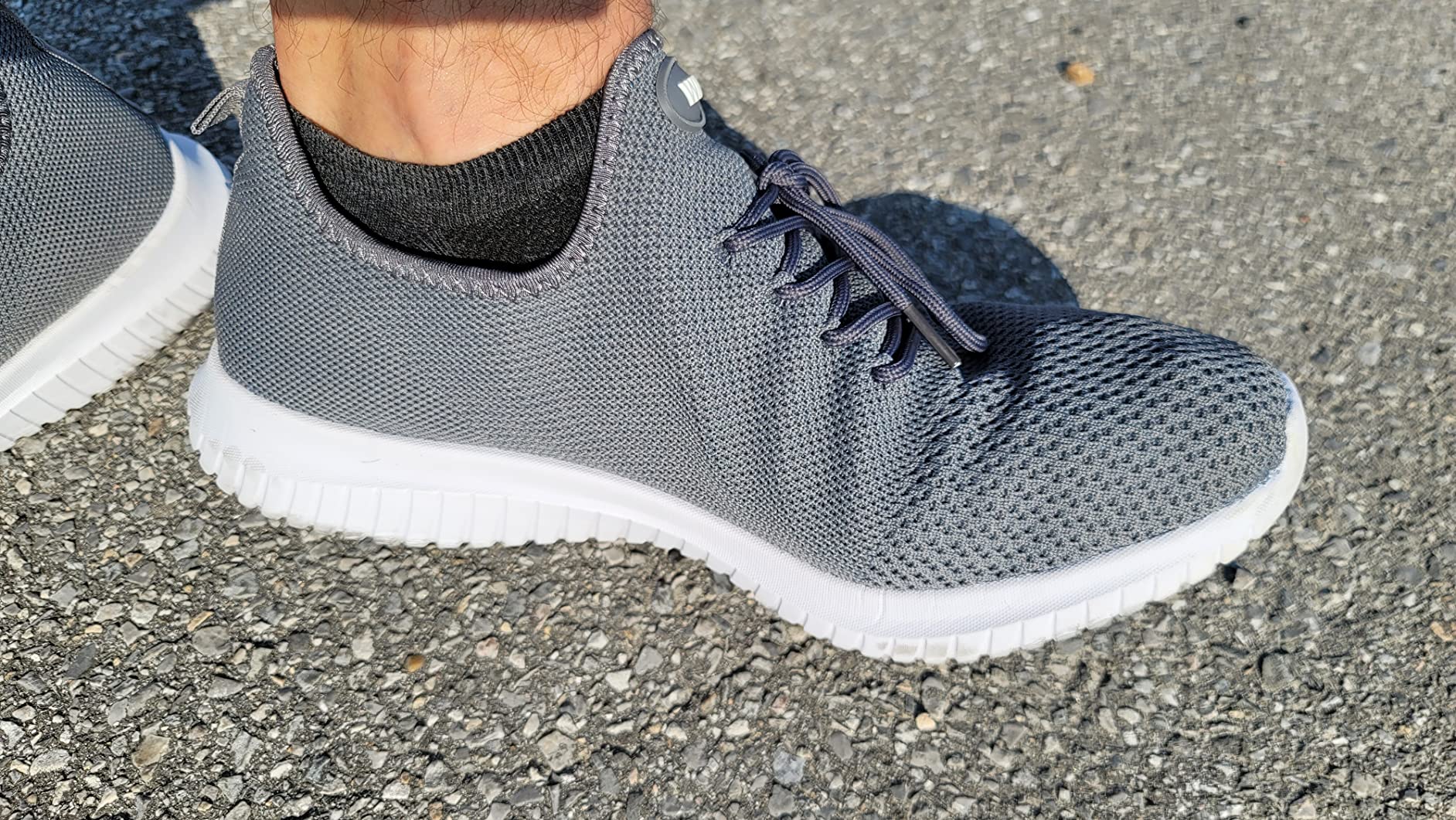 Side profile view of WXQ men's walking shoe showing flat heel design and EVA sole construction