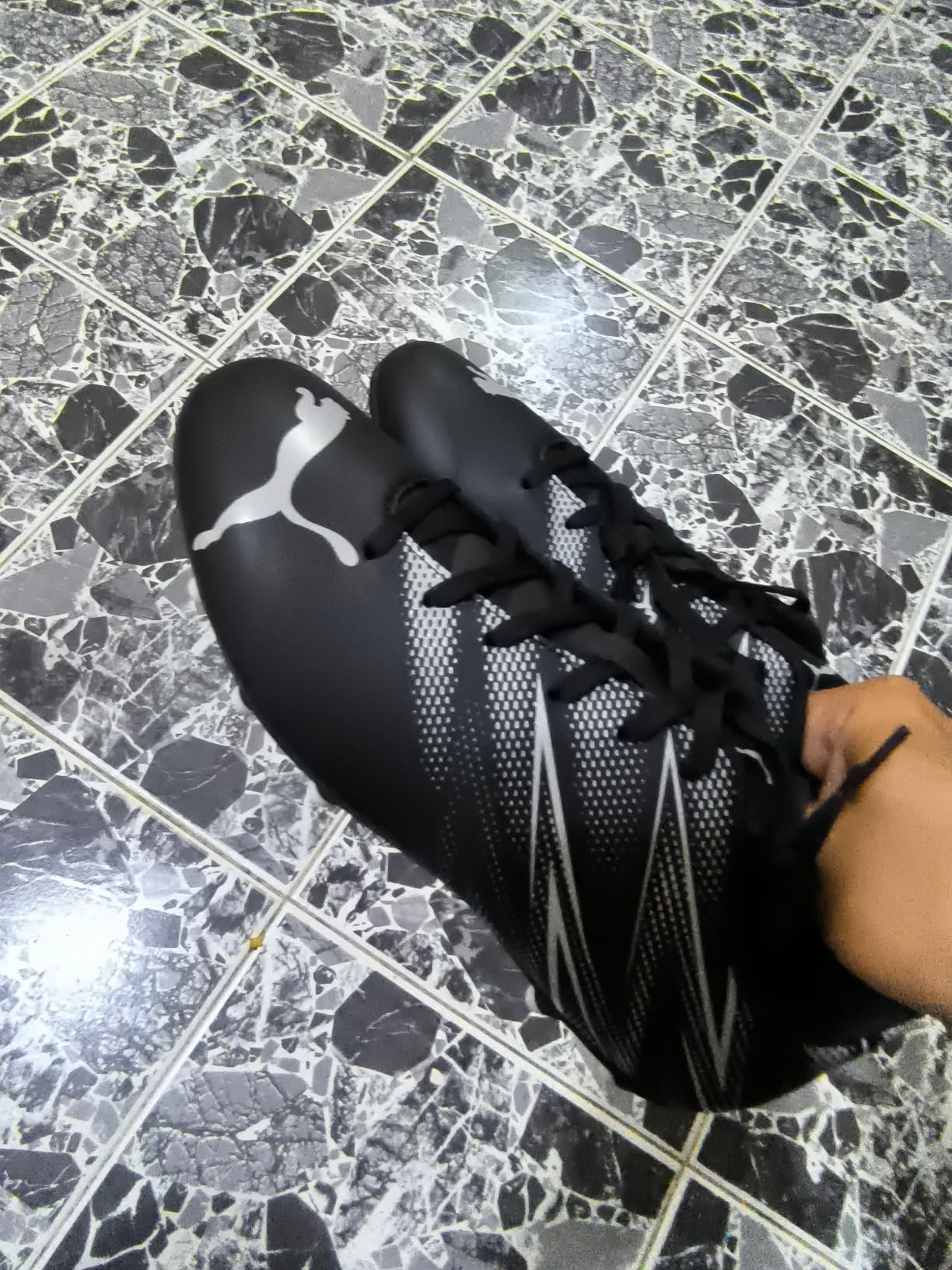 PUMA Men's Attacanto soccer cleats black and silver colorway showing firm ground stud configuration