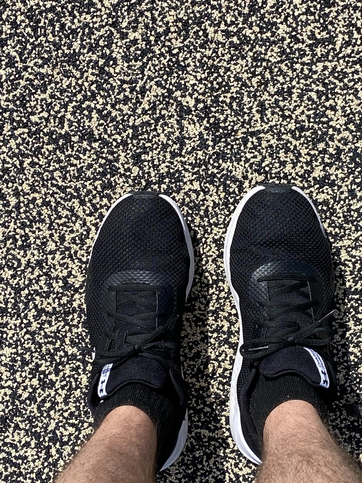 Under Armour Charged Pursuit 3 side profile showing heel construction and midsole technology