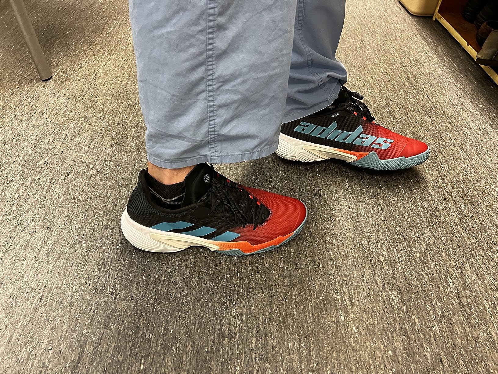 Adidas Men's Barricade Clay tennis shoes showing unique asymmetric lacing system and high ankle support design