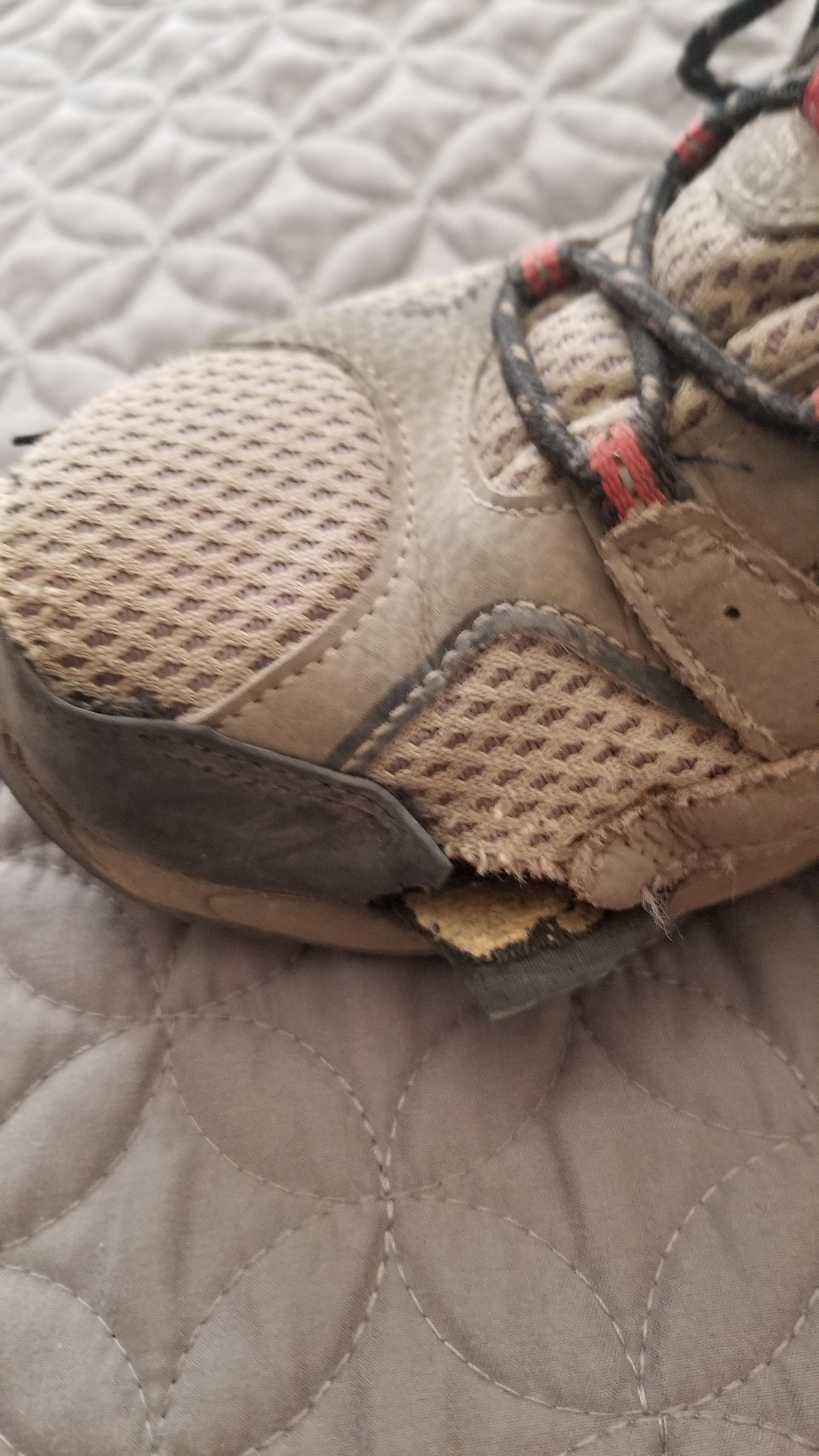 Damaged Merrell Kids Moab 2 showing toe area wear and construction failure