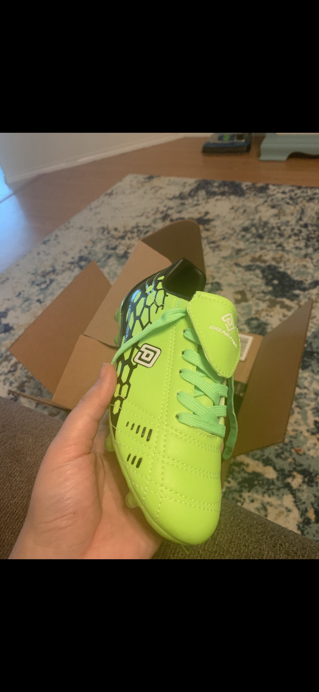 Young player wearing DREAM PAIRS cleats during soccer practice on grass field